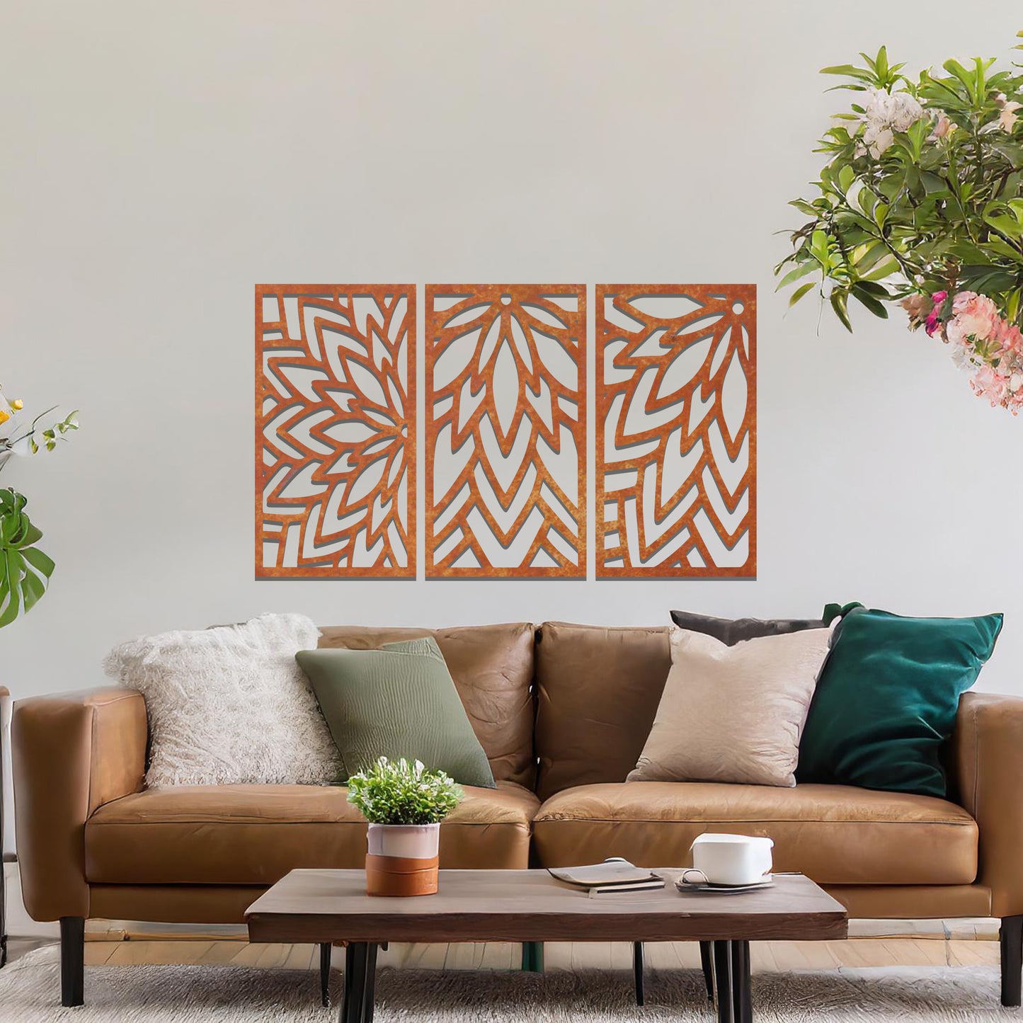 Metal wall art featuring a three-panel design with floral-inspired geometric patterns, crafted with precise laser-cut detailing, displayed on a neutral wall within modern decor.