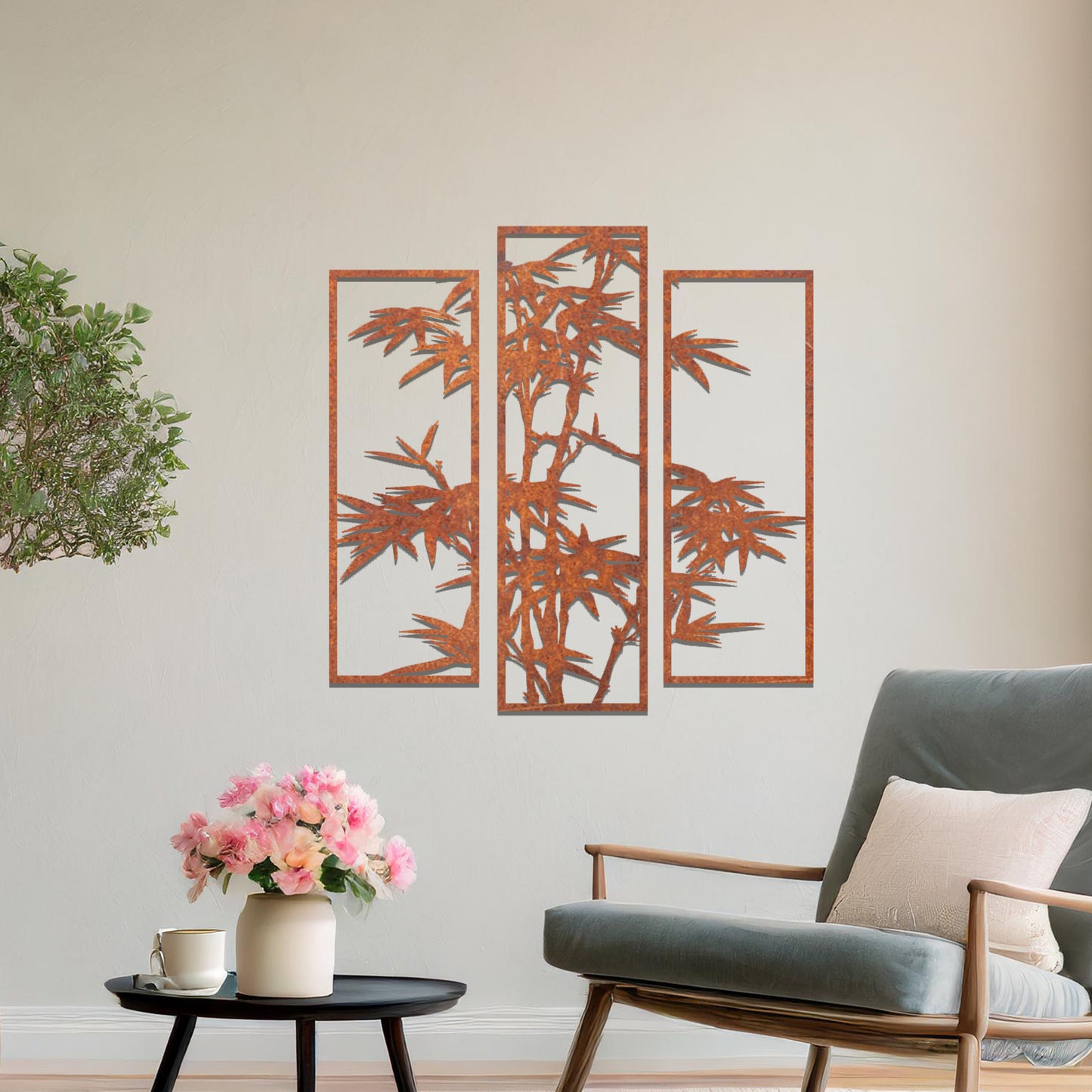 Metal wall art featuring a three-panel bamboo design with intricate leaves and stems, crafted with precise laser-cut detailing, displayed on a neutral wall within modern decor.