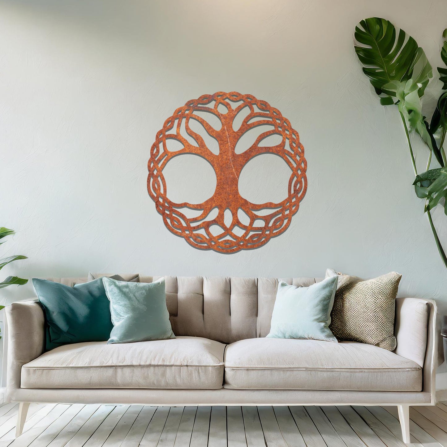 Metal wall art featuring a circular tree of life design with intricately interwoven branches and roots, creating a harmonious and symbolic focal point for the room.