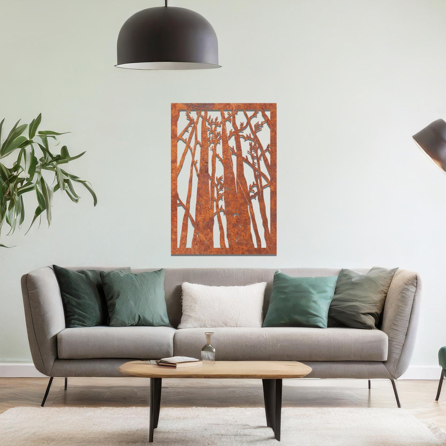 Metal wall art featuring a rectangular design of tall trees with bare branches, showcasing intricate details, displayed on a neutral wall within modern decor.