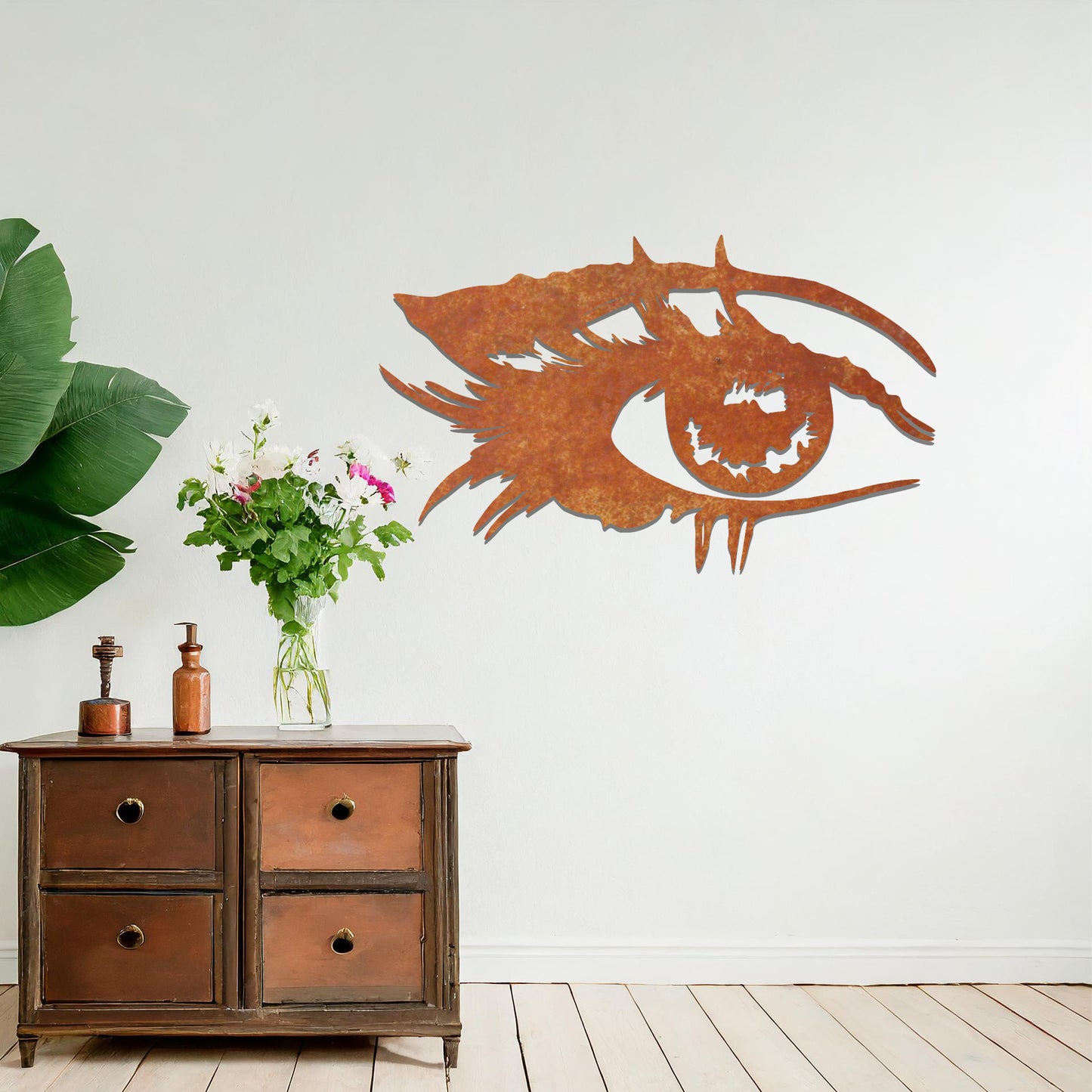 Striking metal wall art featuring a bold and artistic eye design with intricate detailing, mounted on a neutral wall within modern room decor. The focus is entirely on the creative and contemporary craftsmanship of the wall art, enhancing the space's aesthetic appeal.