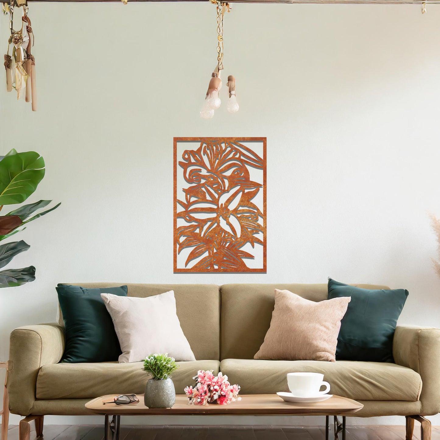 A metal wall art design showcasing a floral pattern with a large flower and leaves, set within a rectangular frame. The art is displayed on a neutral wall in a modern living room, adding an elegant and natural touch to the space.