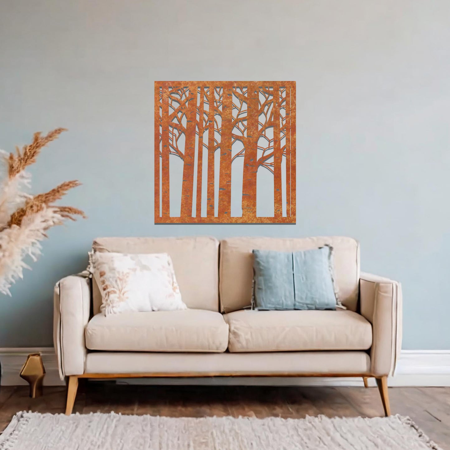Metal wall art featuring a square design with a detailed forest of tall birch trees, mounted on a neutral wall within modern decor. The intricate silhouette adds a natural and elegant focal point to the room.