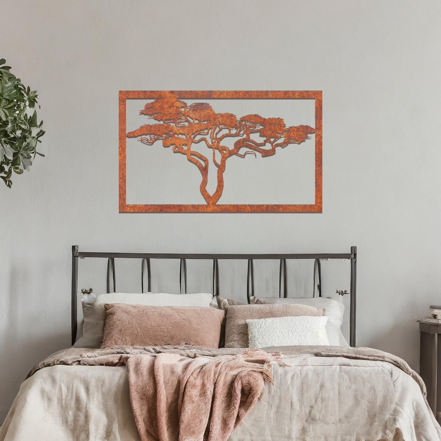 Metal wall art featuring a rectangular design with a silhouette of an African tree, showcasing intricate branch details, mounted on a neutral wall within modern office decor. The elegant craftsmanship adds a natural and sophisticated touch to the contemporary workspace.