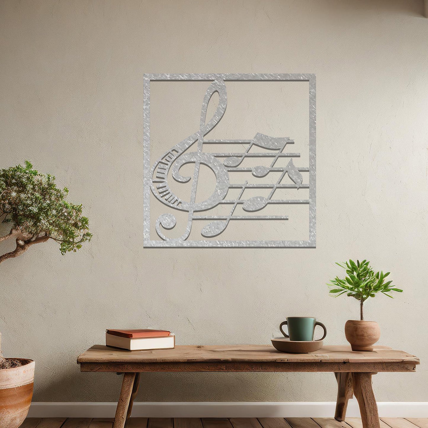 Metal wall art featuring a square design with a treble clef and musical notes on a staff, adding a harmonious and artistic touch to the space.