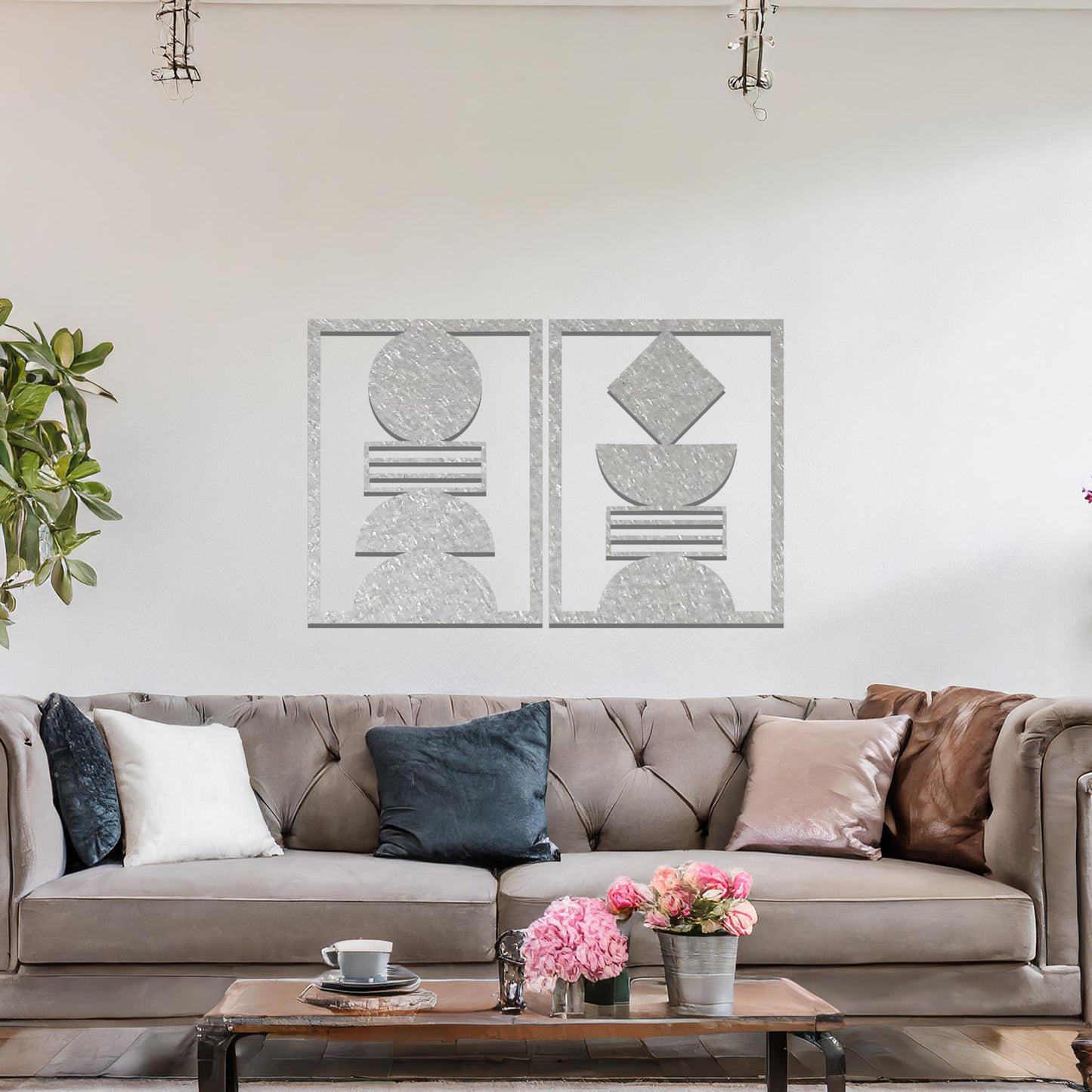 A metal wall art set featuring geometric shapes, including circles and a diamond, arranged in a balanced and symmetrical design. The art is displayed on a neutral wall within modern room decor, adding an elegant and abstract touch to the space.