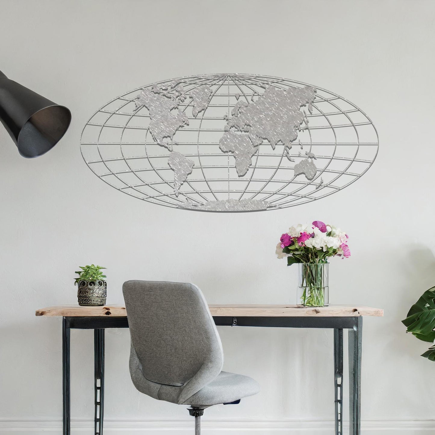 Metal wall art featuring a detailed world map design within an oval grid pattern, crafted with precise laser-cut techniques, displayed on a neutral wall within modern decor.