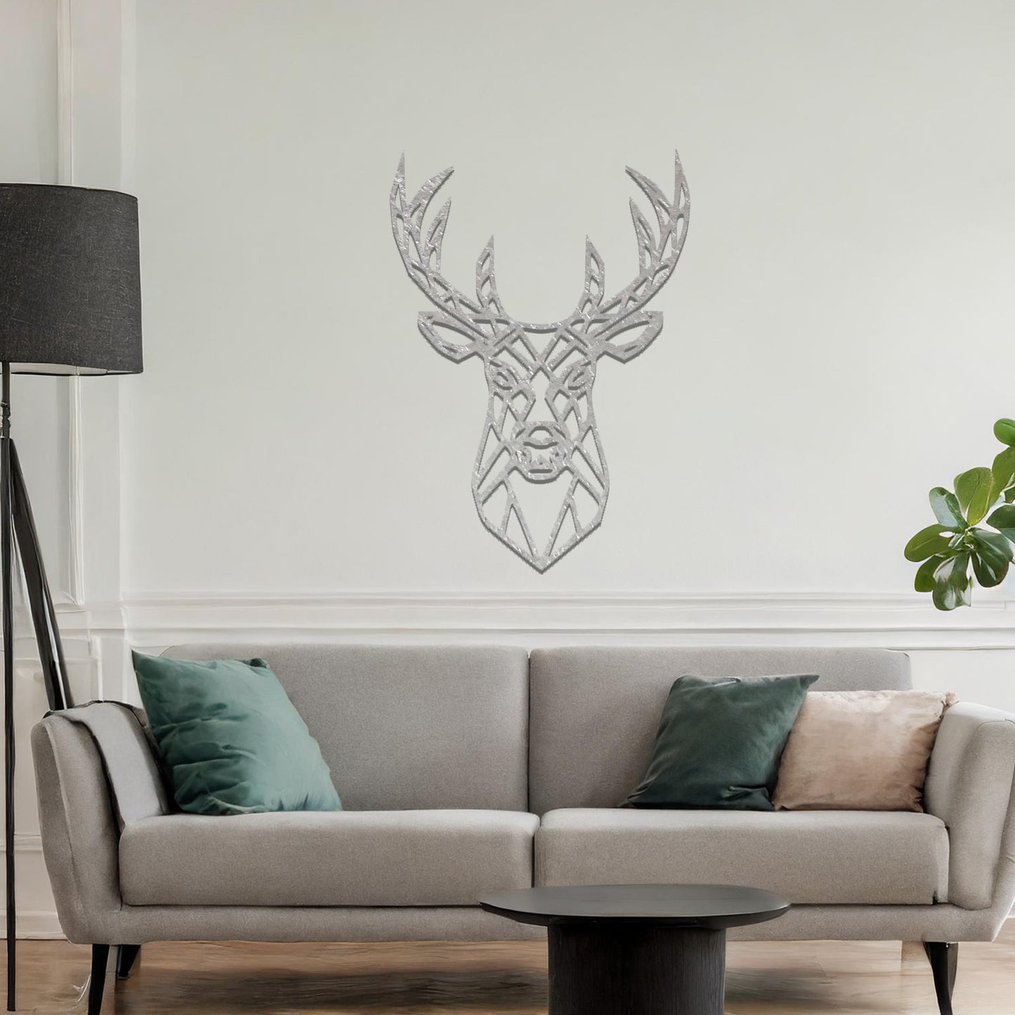 Metal wall art featuring a geometric deer head design with intricate detailing, crafted with precise laser-cut techniques, displayed on a neutral wall within modern decor.