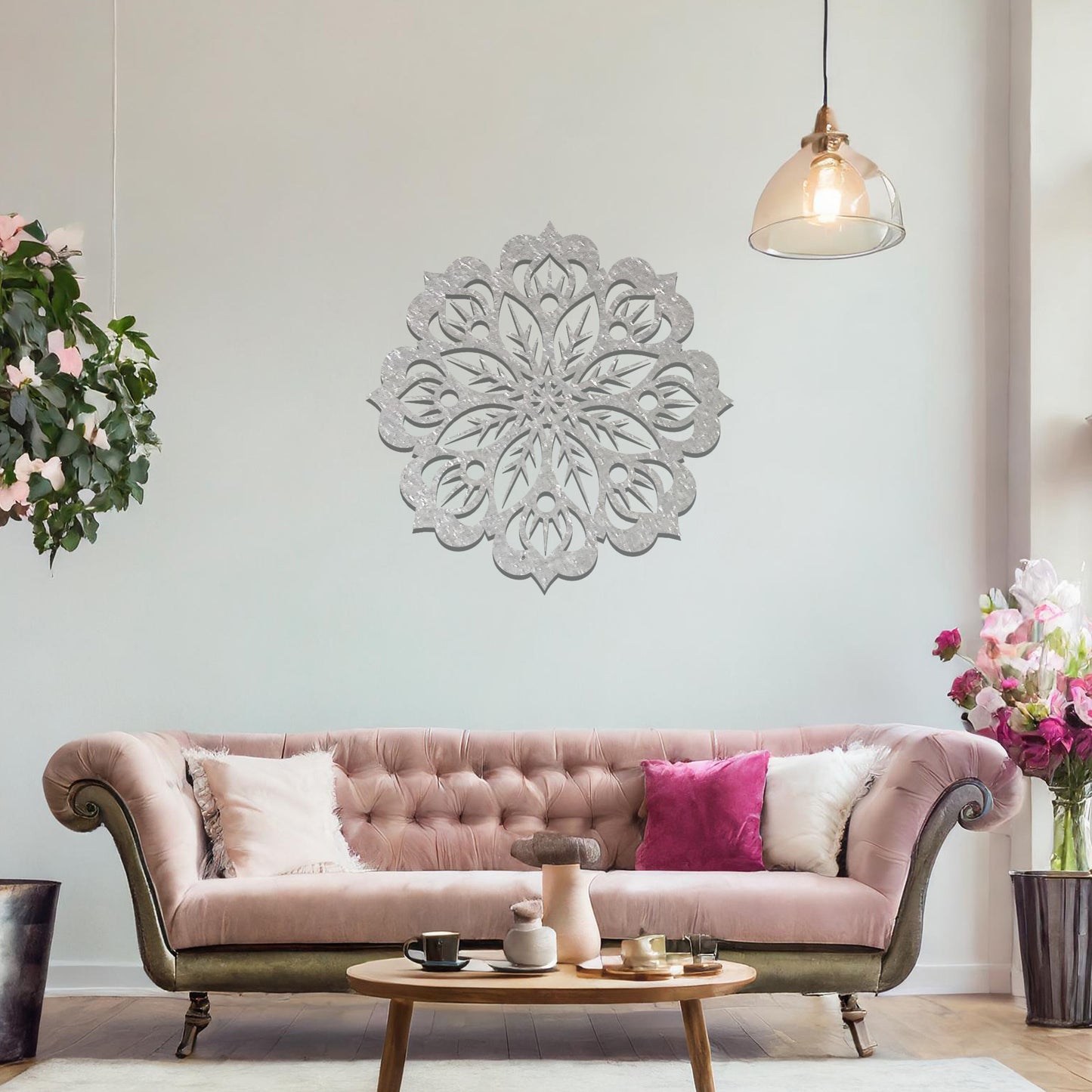 Metal wall art featuring an intricate mandala design with symmetrical floral patterns, mounted on a neutral wall within modern room decor. The detailed craftsmanship and balanced geometry create a striking focal point, enhancing the sophistication of the space.