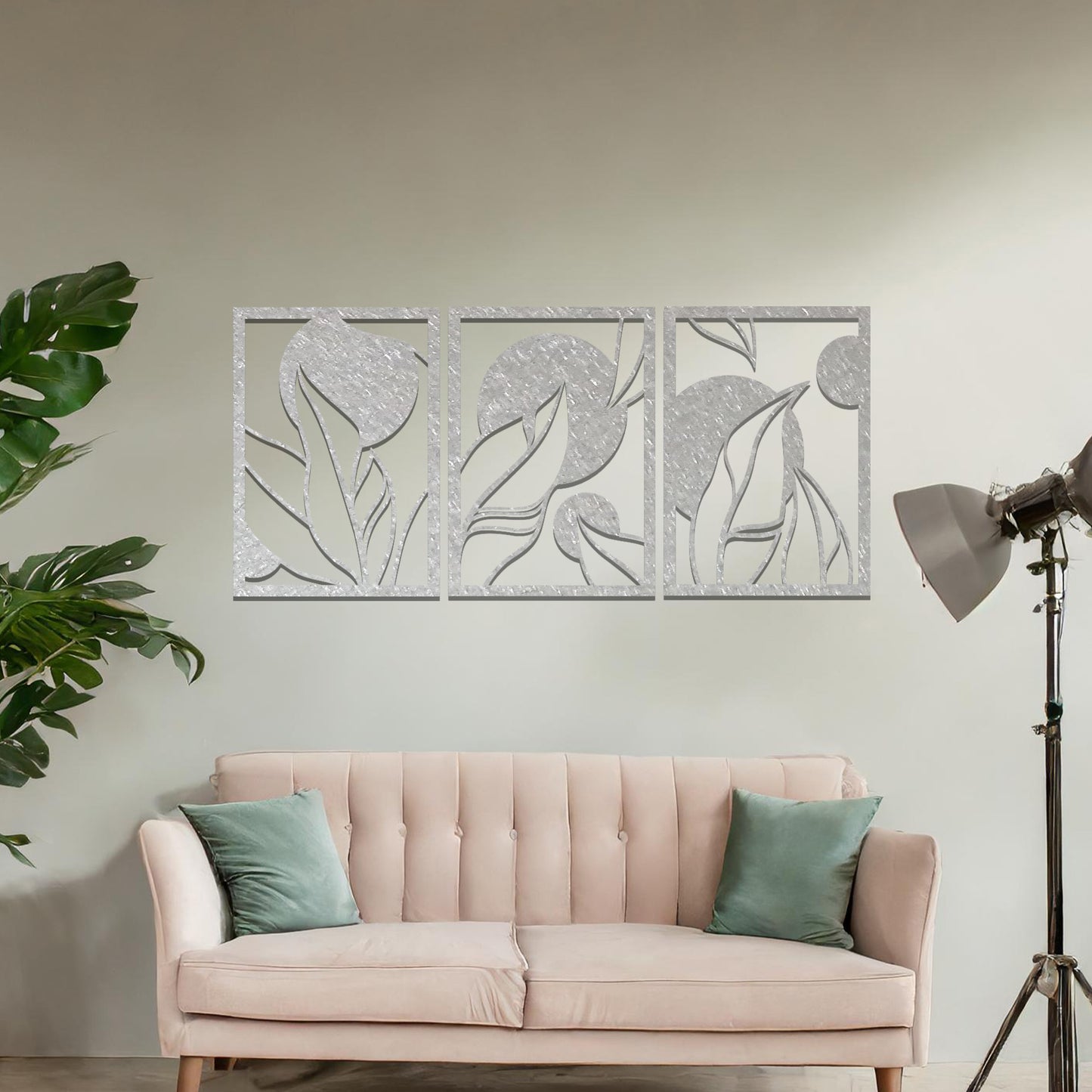 Metal wall art featuring a three-panel design with abstract floral and circular elements, mounted on a neutral wall within modern decor. The rust finish and fluid shapes create a warm and artistic focal point in the room.