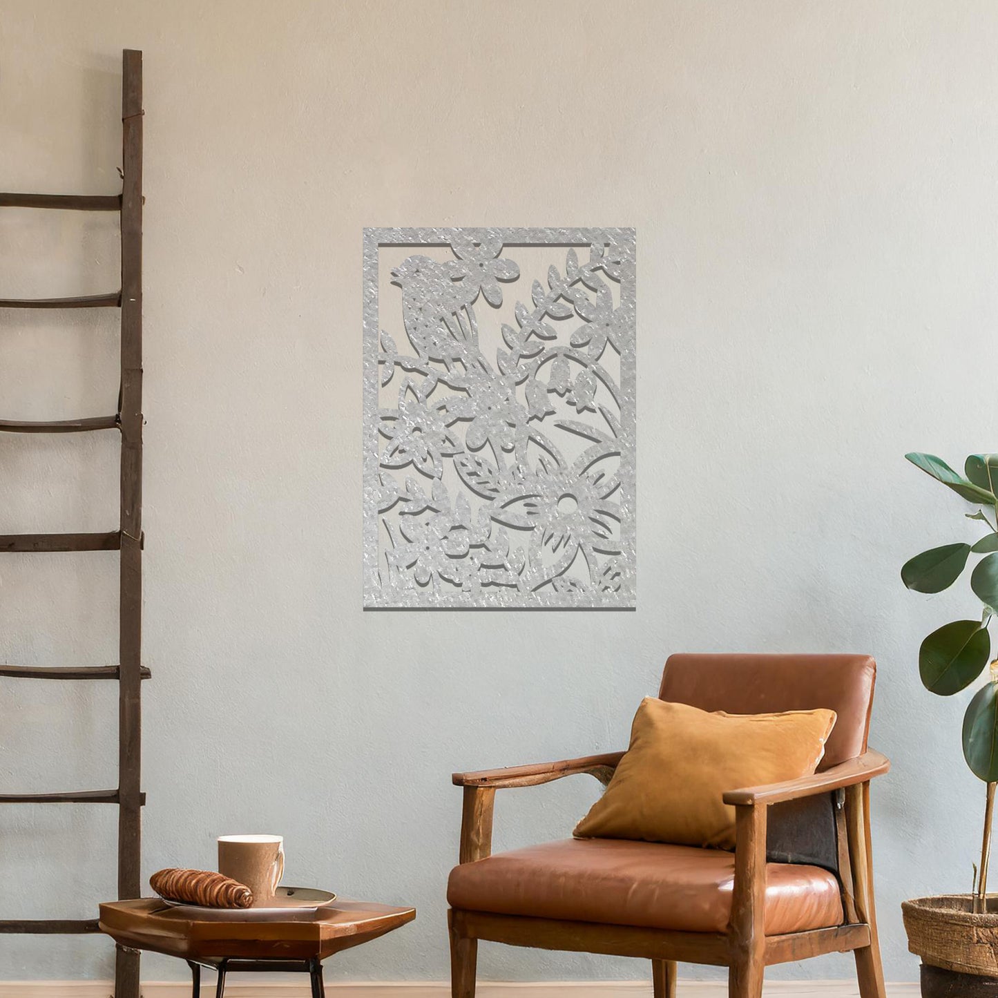 Metal wall art featuring a rectangular design with a bird perched amidst detailed floral and leafy patterns, mounted on a neutral wall within modern room decor. The intricate details and natural elements create a lively and elegant focal point.