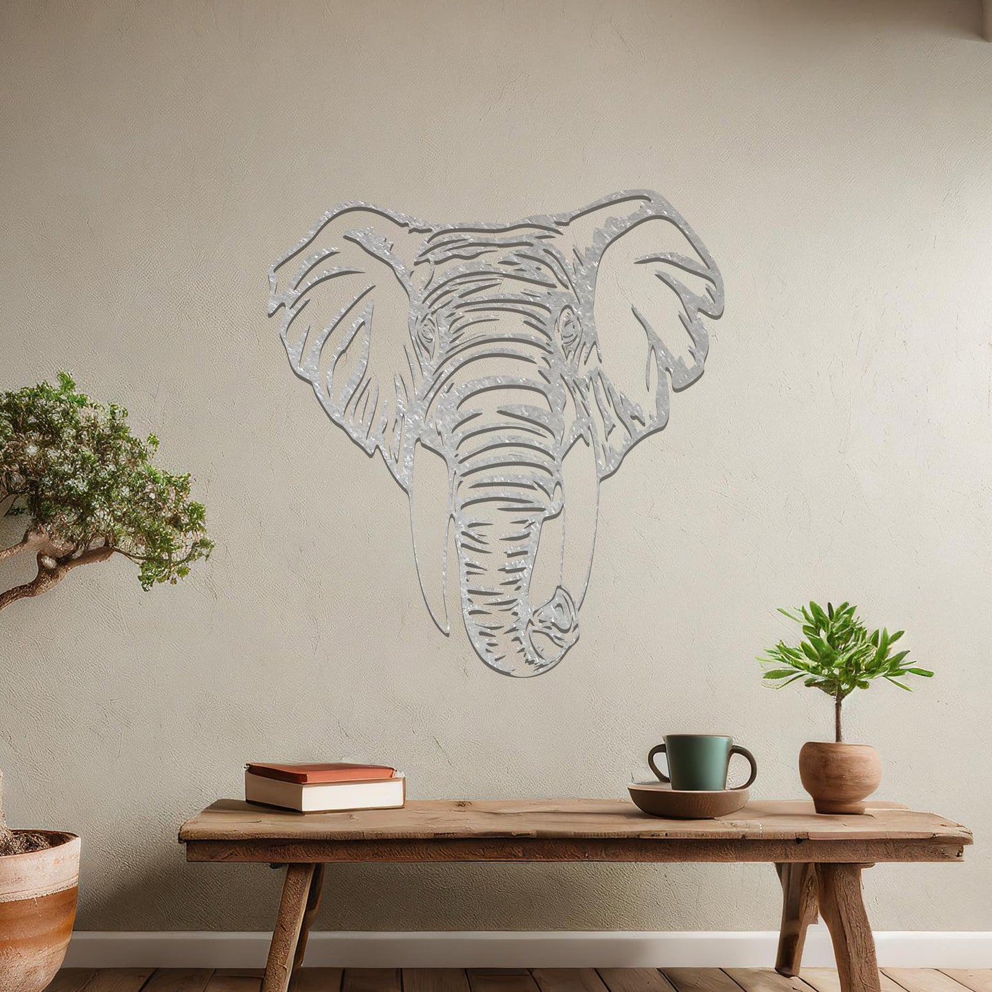Metal wall art featuring a detailed elephant head design with intricate lines and realistic features, crafted with precise laser-cut techniques, displayed on a neutral wall within modern decor.
