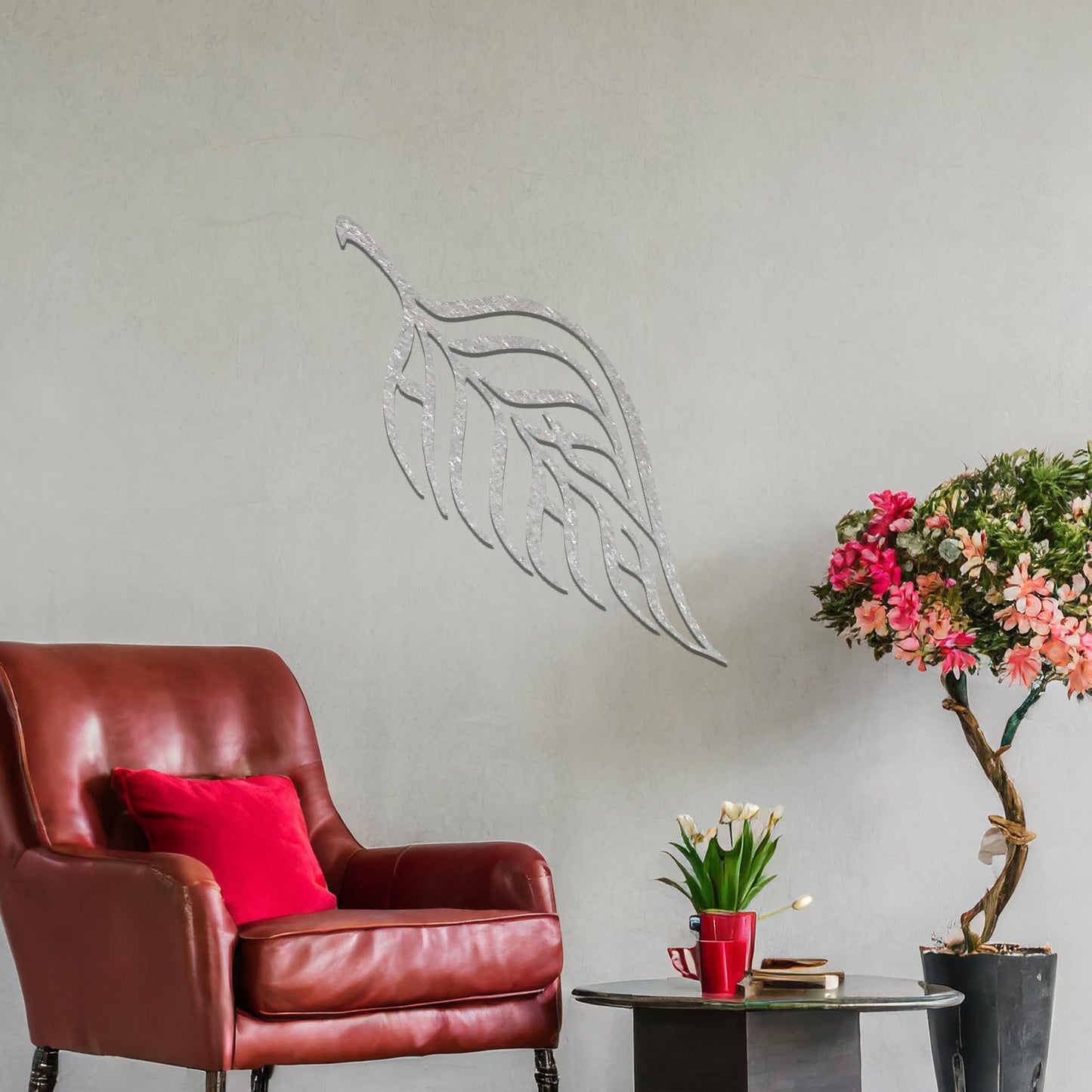 Metal wall art featuring a stylised leaf design with intricate linework and the word "Allah" seamlessly incorporated, mounted on a neutral wall within modern room decor. The elegant craftsmanship and spiritual motif make it a striking focal point in the space.