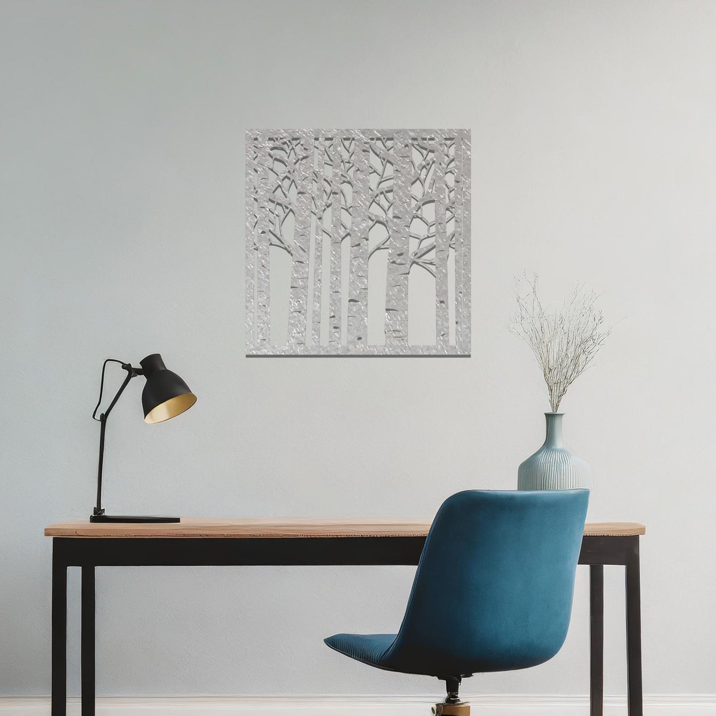 Metal wall art featuring a square design with a detailed forest of tall birch trees, mounted on a neutral wall within modern decor. The intricate silhouette adds a natural and elegant focal point to the room.