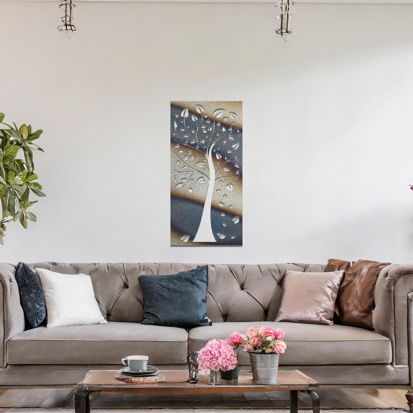 Metal wall art featuring a tree with intricate branches and leaves, enclosed in a vertical rectangular frame. The artwork is displayed on a neutral wall within a modern office setting, complemented by a desk, chair, and indoor plants.