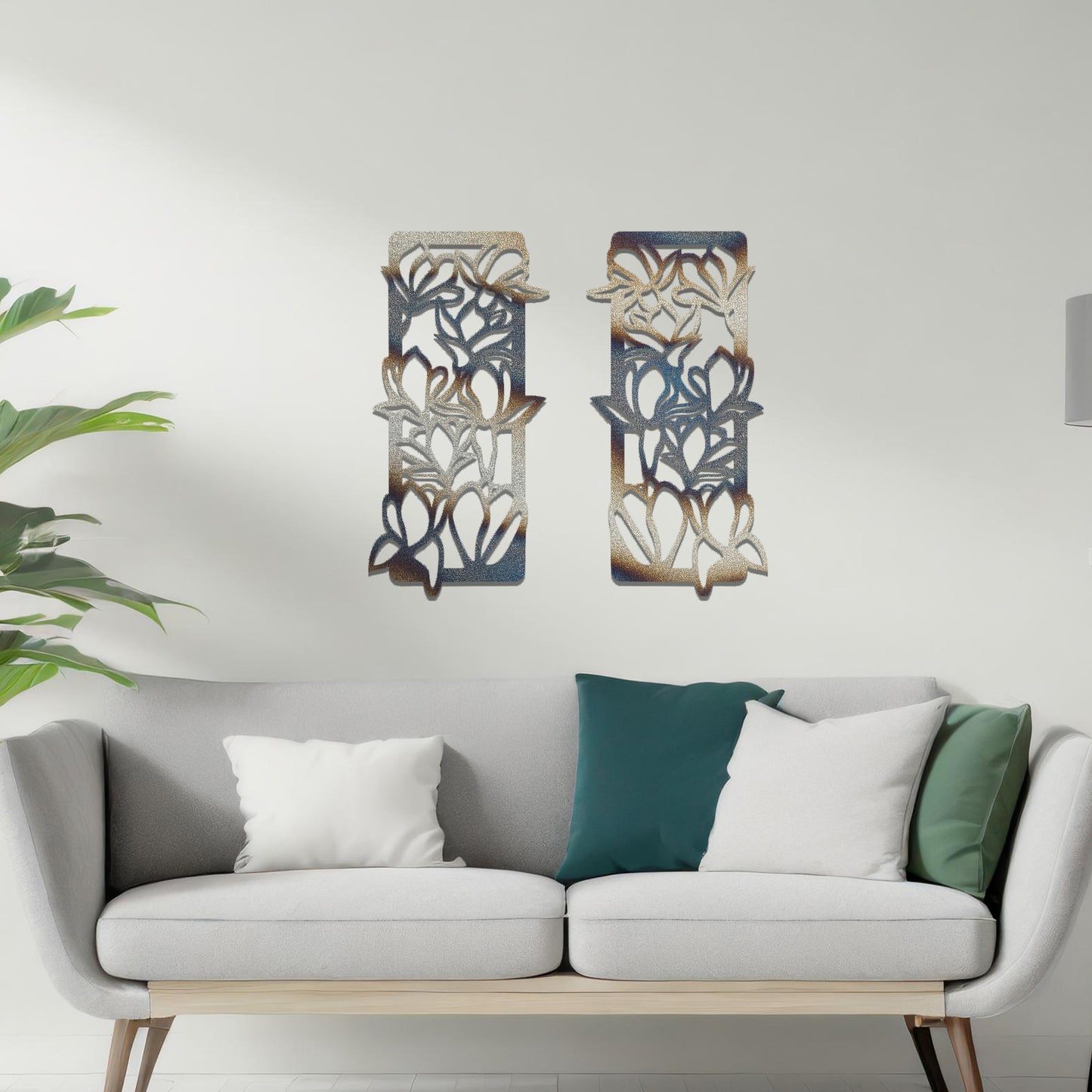 Metal wall art featuring a pair of vertical panels with floral-inspired designs of intertwined stems and leaves, crafted with precise laser-cut detailing, displayed on a neutral wall within modern decor.