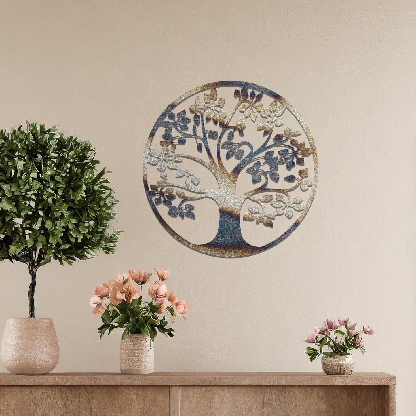 Metal wall art featuring a circular tree design with a detailed trunk, branches, and leaves, crafted with precise laser-cut techniques, displayed on a neutral wall within modern decor.