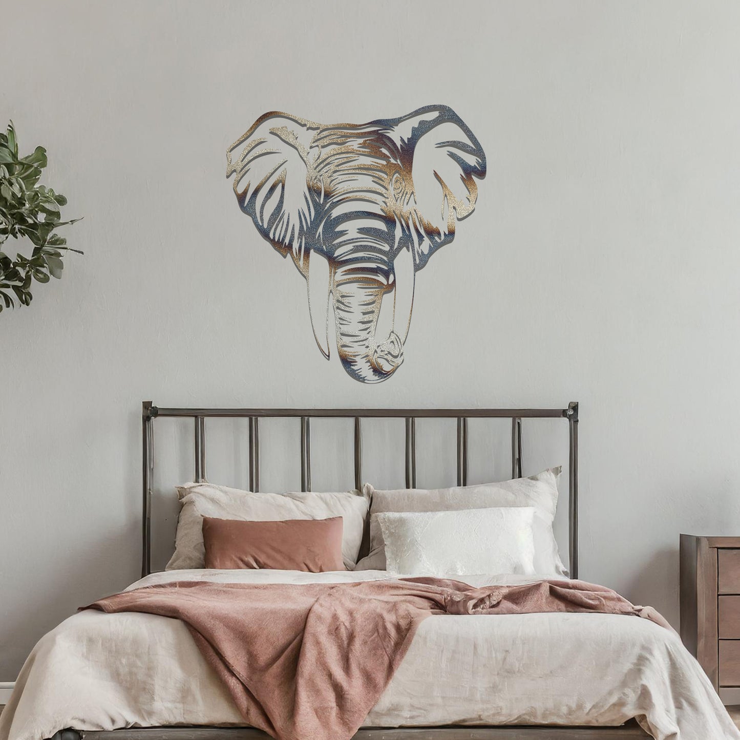 Metal wall art featuring a detailed elephant head design with intricate lines and realistic features, crafted with precise laser-cut techniques, displayed on a neutral wall within modern decor.