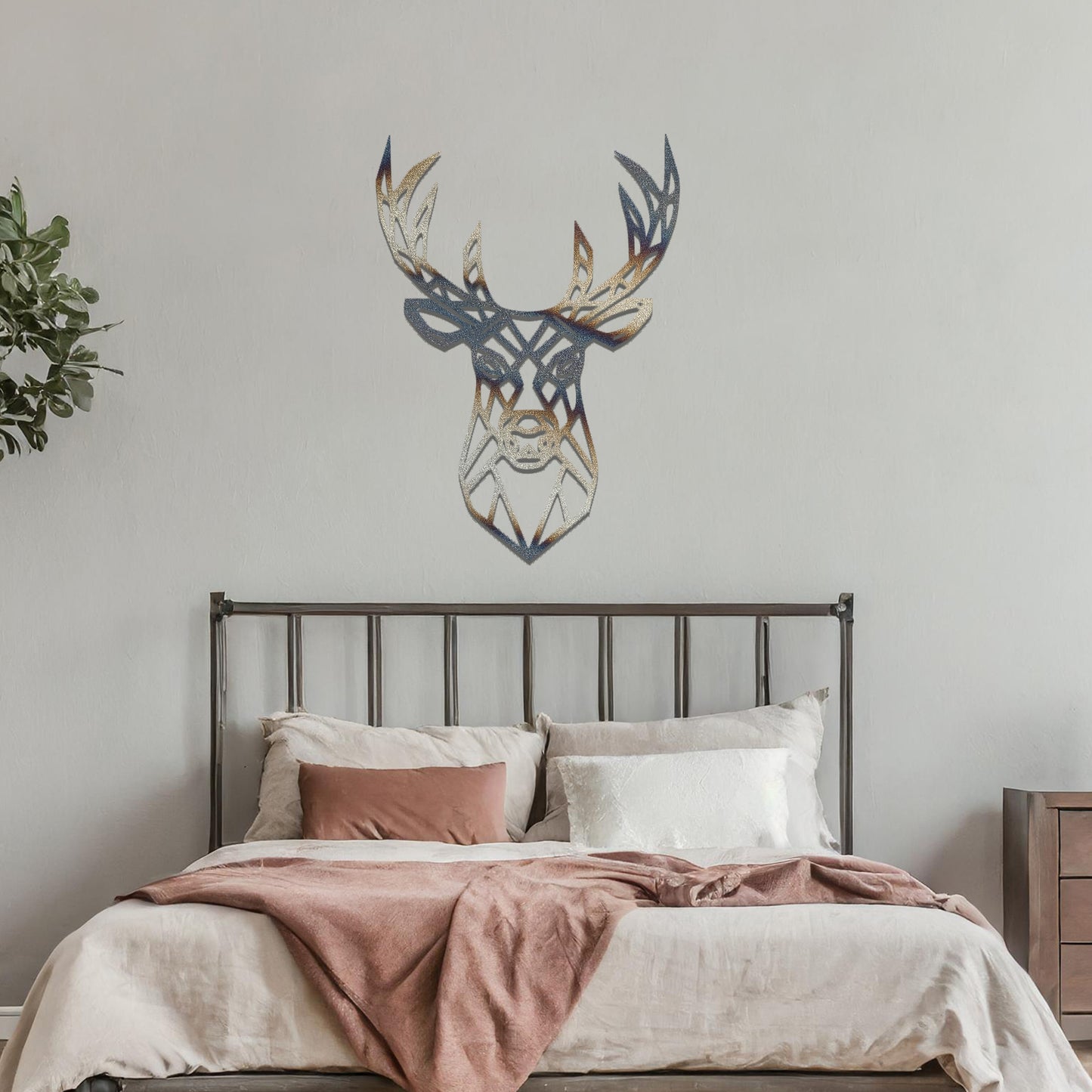 Metal wall art featuring a geometric deer head design with intricate detailing, crafted with precise laser-cut techniques, displayed on a neutral wall within modern decor.