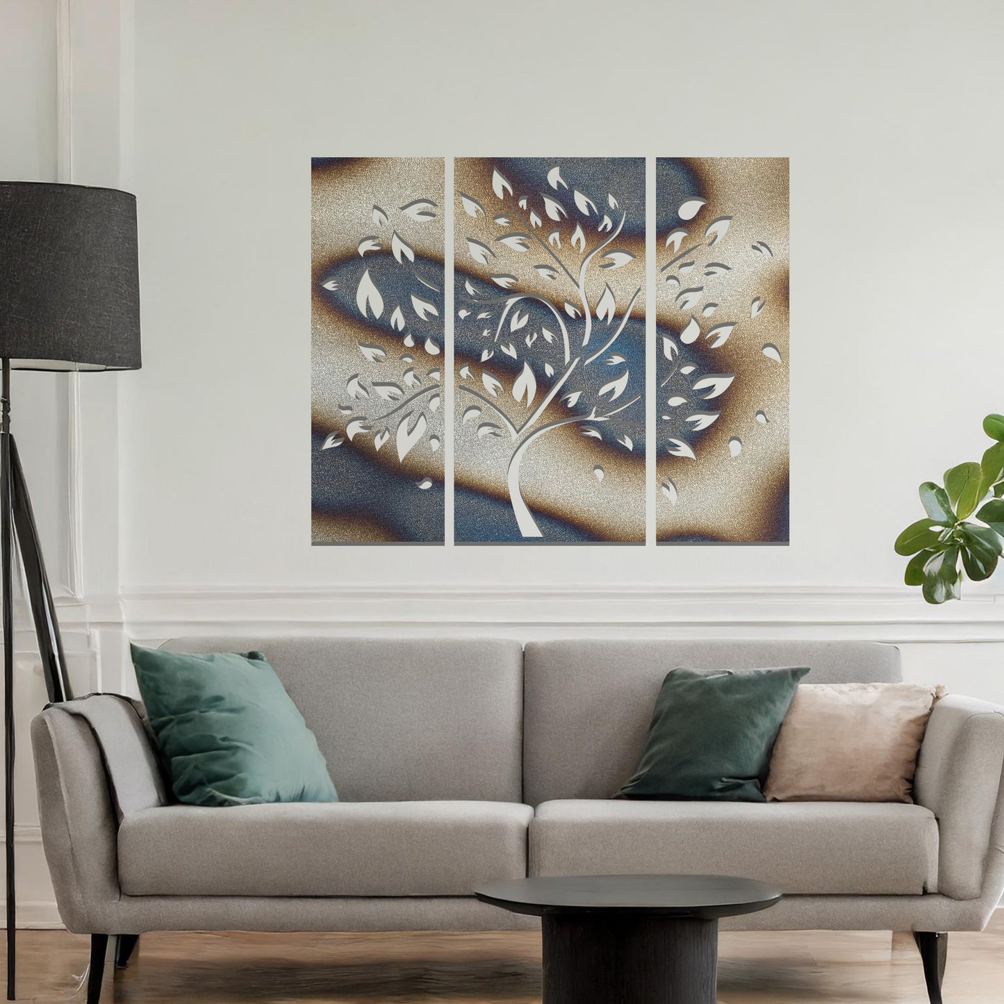 Metal wall art featuring a three-panel tree design with curved branches and delicate leaves, crafted with precise laser-cut detailing, displayed on a neutral wall within modern decor.