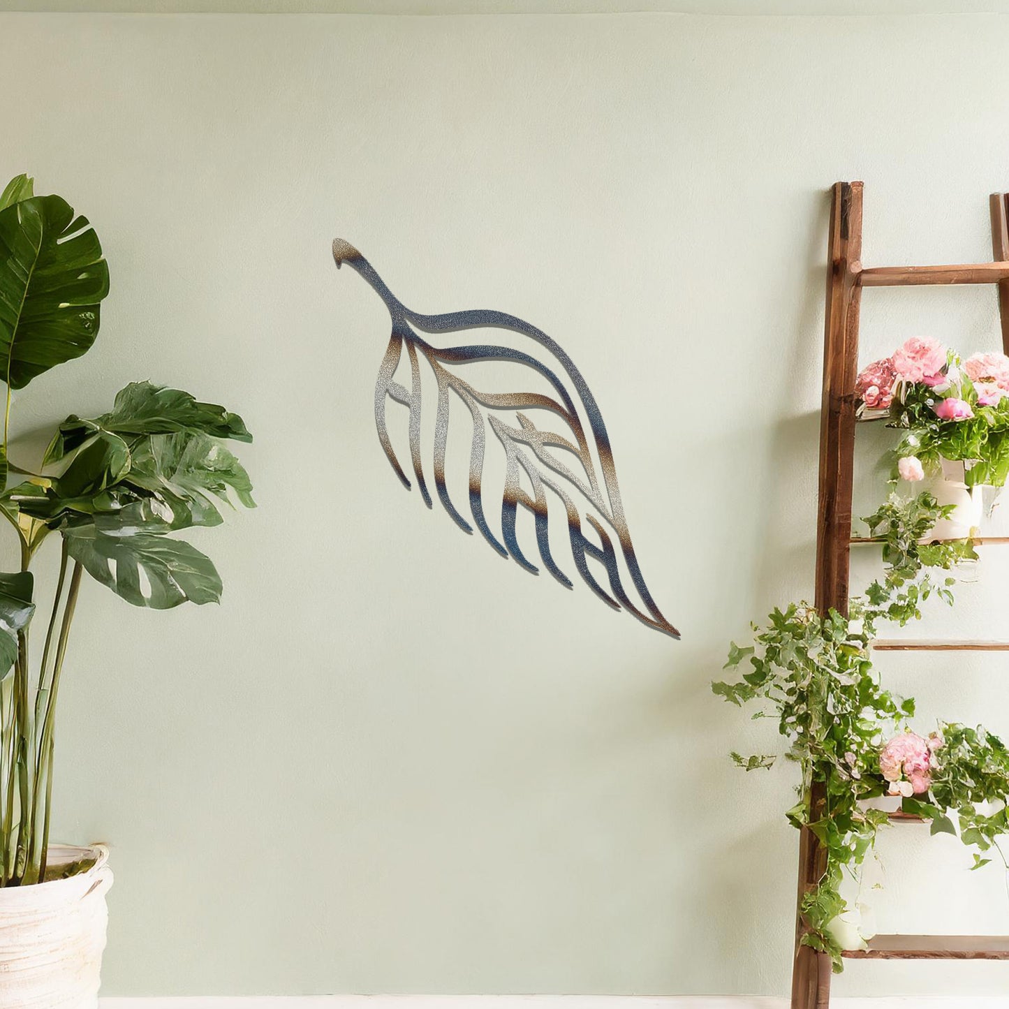 Metal wall art featuring a stylised leaf design with intricate linework and the word "Allah" seamlessly incorporated, mounted on a neutral wall within modern room decor. The elegant craftsmanship and spiritual motif make it a striking focal point in the space.