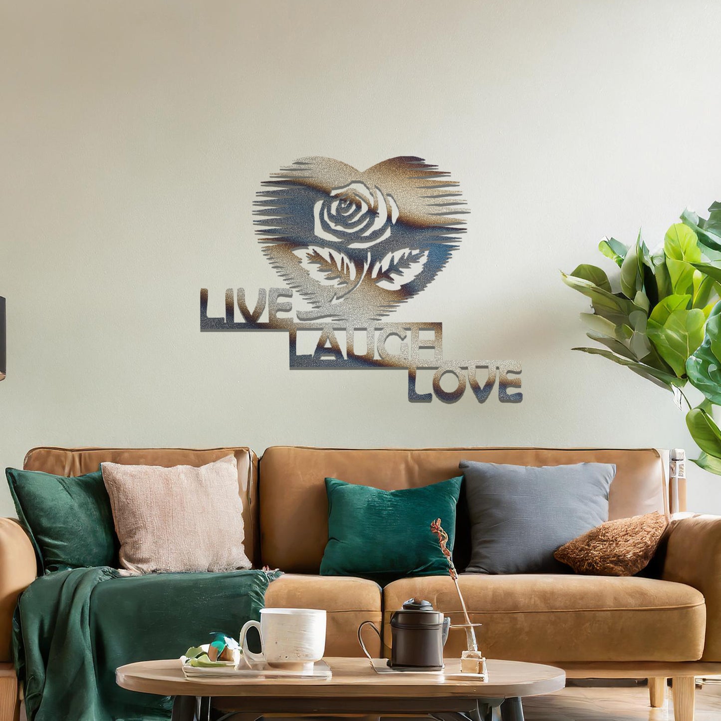Metal wall art featuring the words "LIVE LAUGH LOVE" alongside a rose within a heart shape, with bold lines and intricate design. The art is displayed on a neutral wall within modern room decor, offering a stylish and motivational accent to the space.