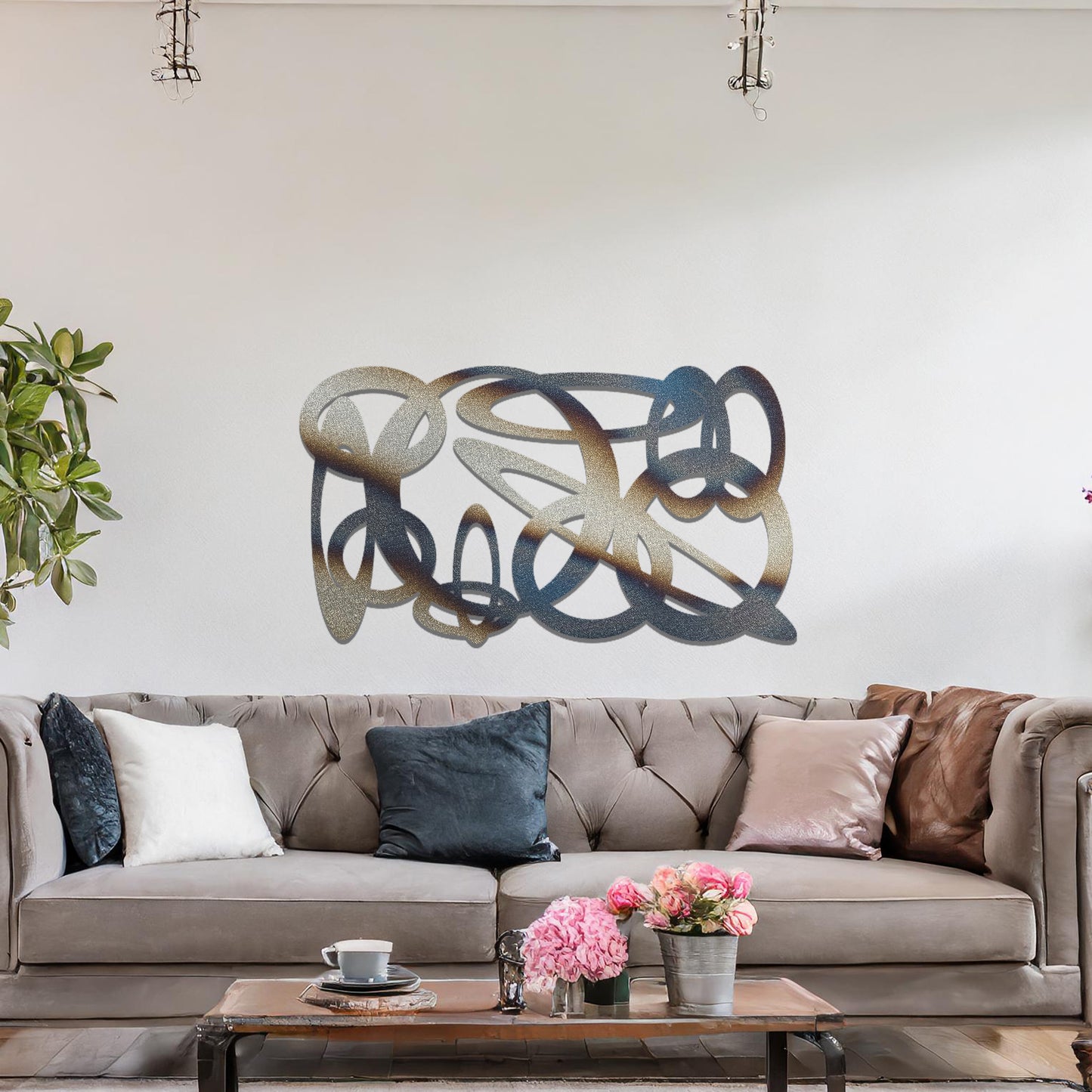 Metal wall art featuring a dynamic, abstract design with overlapping loops and curves. The art is placed on a neutral wall within modern room decor, creating a bold and fluid statement in the space.