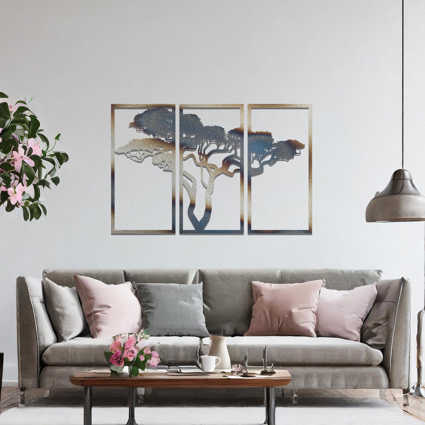 Metal wall art featuring a three-panel design with a stylised tree silhouette, mounted on a neutral wall within a modern artistic setting. The rust finish and detailed tree branches create a natural and calming focal point for the room.
