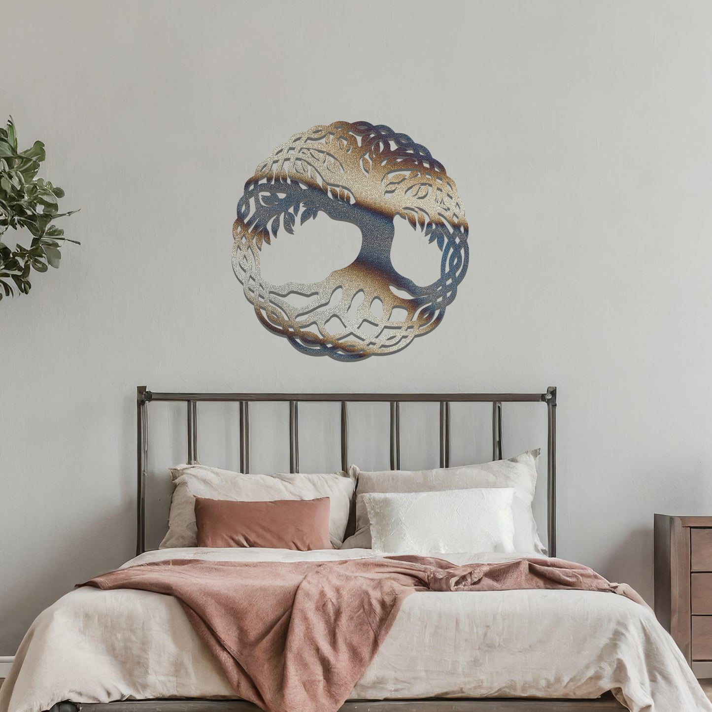 Metal wall art featuring a circular tree of life design with intricate roots and branches enclosed in a detailed border, crafted with precise laser-cut techniques, displayed on a neutral wall within modern decor.