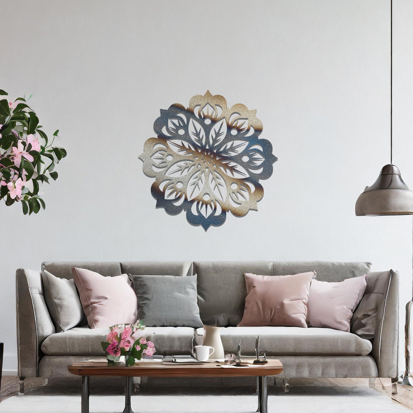 Metal wall art featuring an intricate mandala design with symmetrical floral patterns, mounted on a neutral wall within modern room decor. The detailed craftsmanship and balanced geometry create a striking focal point, enhancing the sophistication of the space.