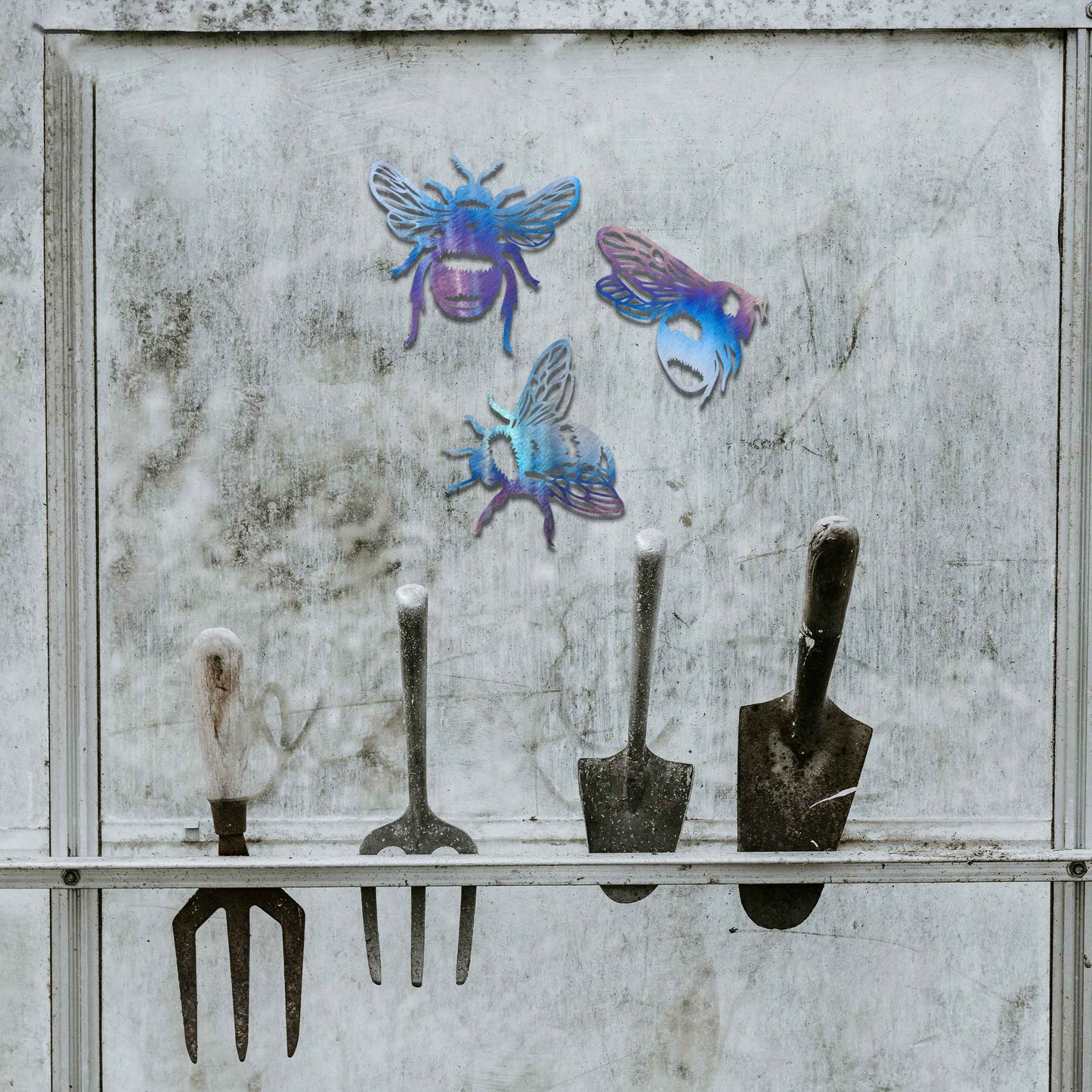 Set of metal garden decorations featuring three detailed bee designs, each showcasing intricate wing and body patterns, perfect for adding a playful and nature-inspired touch to outdoor spaces or fences.