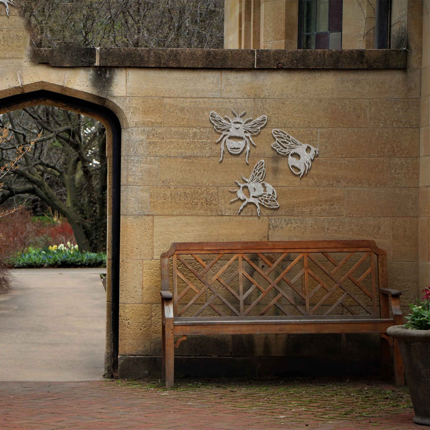 Set of metal garden decorations featuring three detailed bee designs, each showcasing intricate wing and body patterns, perfect for adding a playful and nature-inspired touch to outdoor spaces or fences.