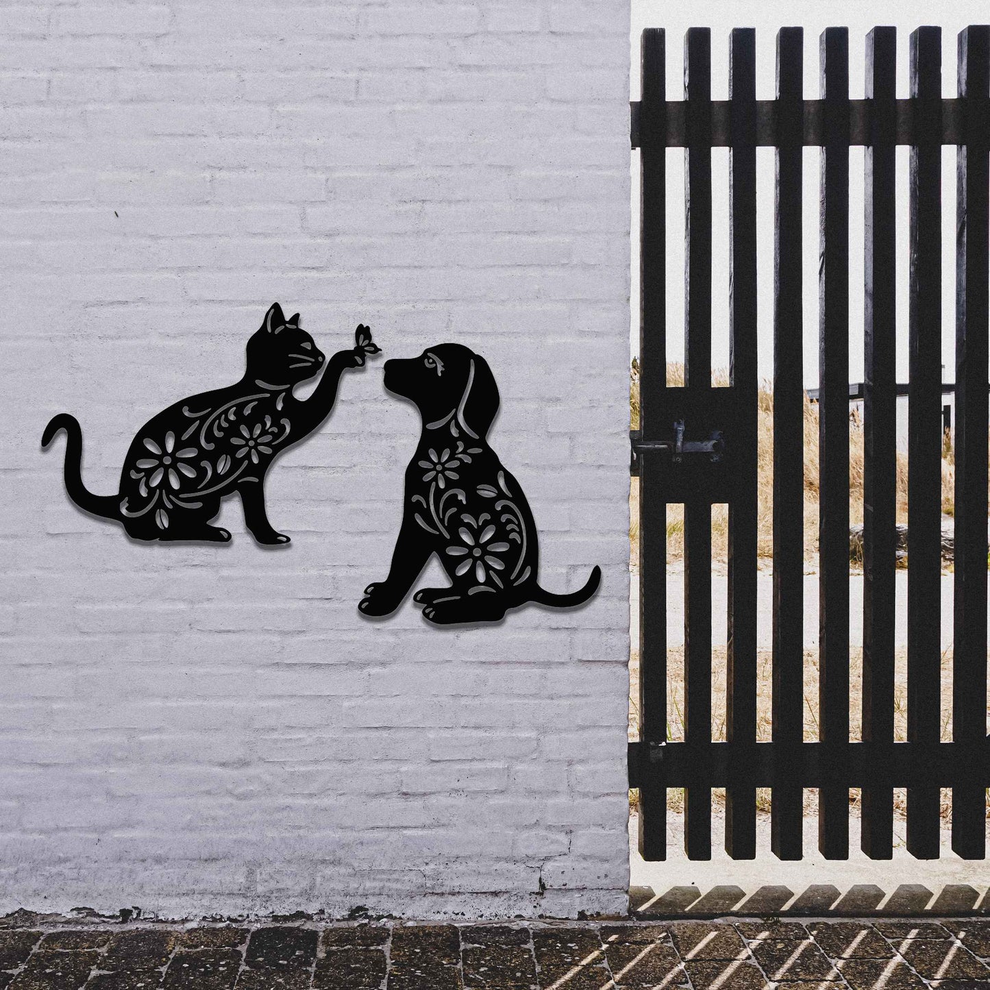 Metal garden decoration set featuring a playful cat reaching for a butterfly and a sitting dog, both adorned with intricate floral patterns, adding a whimsical and charming touch to outdoor walls or fences.