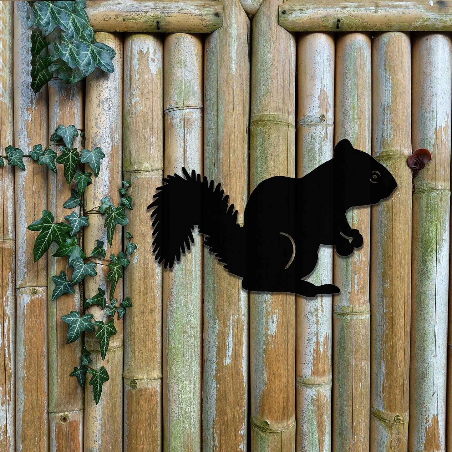 Metal garden decoration featuring a squirrel silhouette with a textured design, adding a rustic and playful accent to outdoor walls, complementing natural and minimalist garden aesthetics.