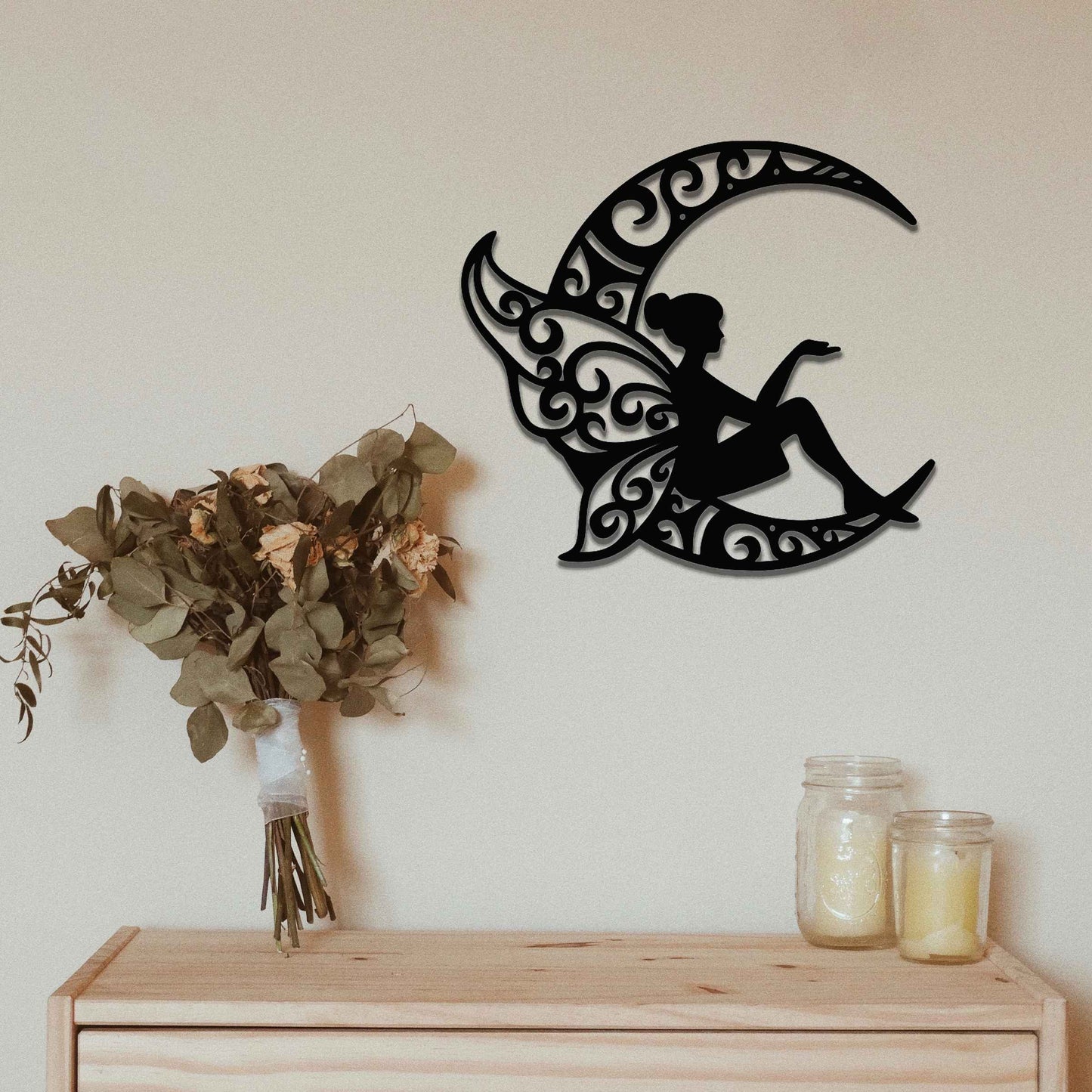 This design features a fairy seated gracefully on a crescent moon, with intricate, swirling patterns on the moon and the fairy’s wings. The detailed curves and flowing lines of the design create a whimsical, peaceful atmosphere, perfect for adding a touch of magic to any room.