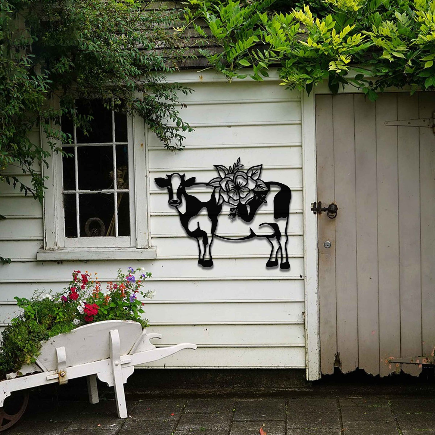 The artwork showcases a cow adorned with a detailed floral design on its back. The cow's form is outlined in a minimalist style, with the intricate flowers contrasting against its simple body, adding a decorative and natural element to the piece.