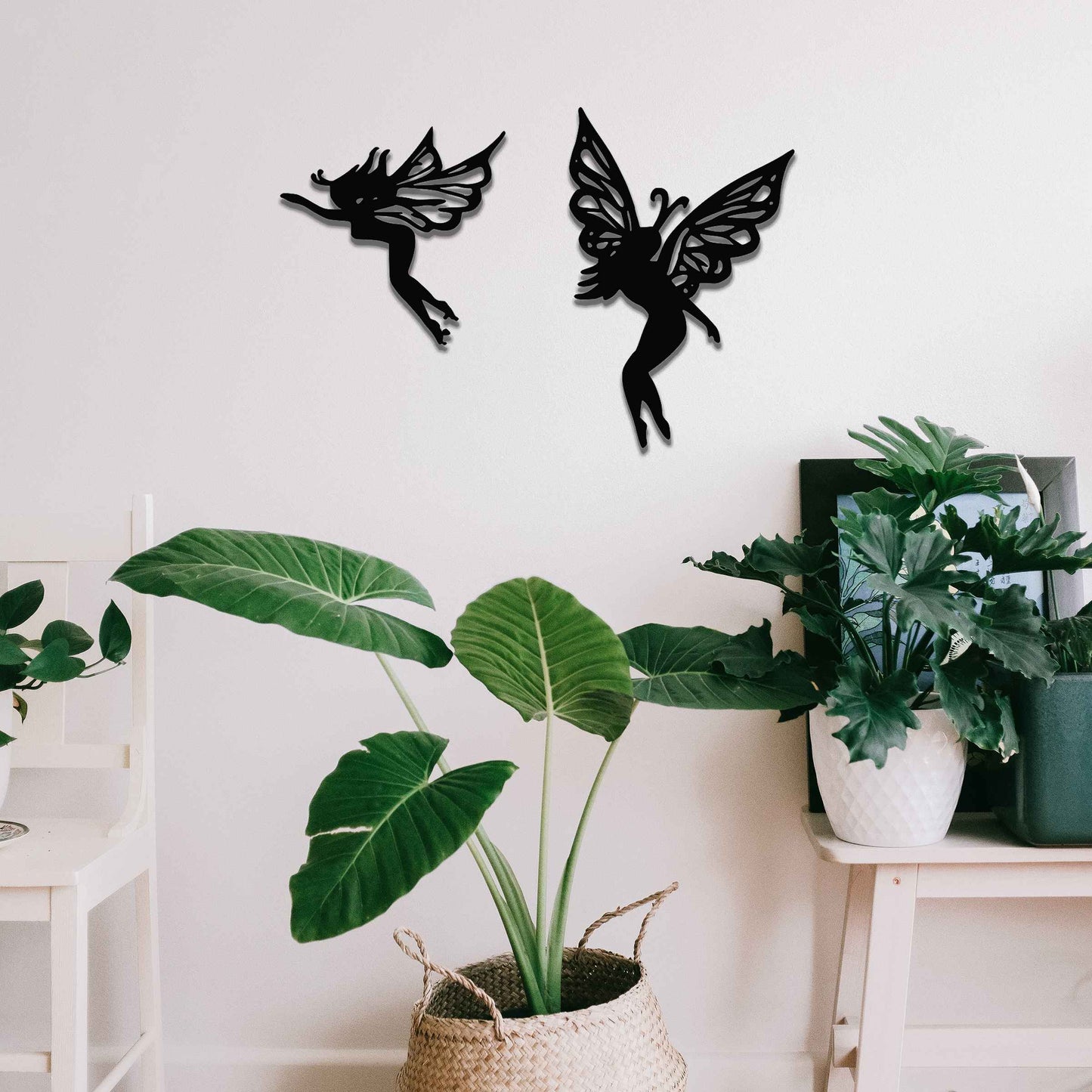 The image depicts two graceful fairies with intricate wings, suspended in mid-air. Their delicate, elegant figures evoke a sense of lightness and magic, adding a whimsical touch to any space, perfect for creating an enchanting atmosphere.