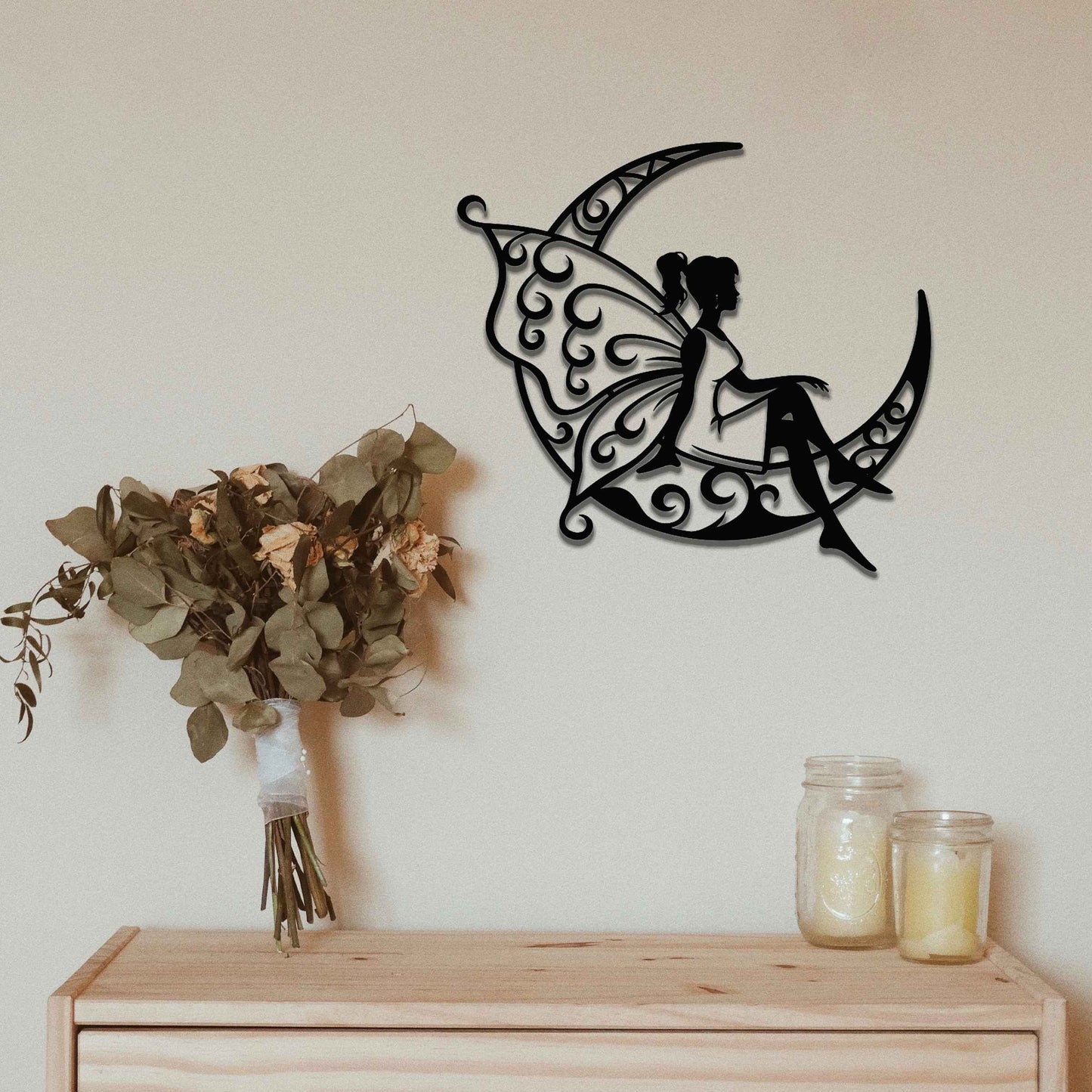 This design shows a fairy sitting on a crescent moon, with elegantly detailed, swirling patterns adorning both the moon and her wings. The graceful pose of the fairy and the intricate designs create a dreamy and whimsical atmosphere, perfect for adding a touch of magic to any space.