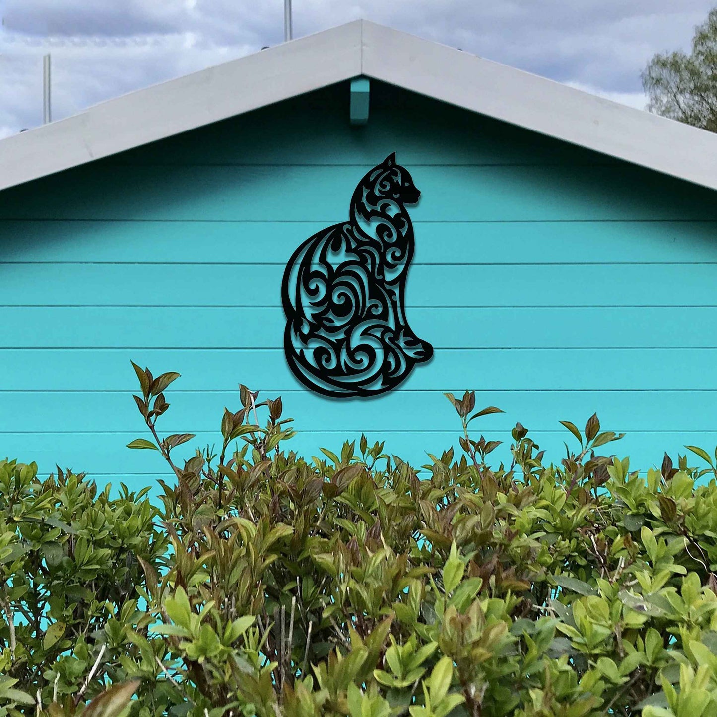 This design features a silhouette of a cat in profile, its body adorned with intricate swirls and patterns. The cat sits gracefully, showcasing elegant detailing throughout the design.