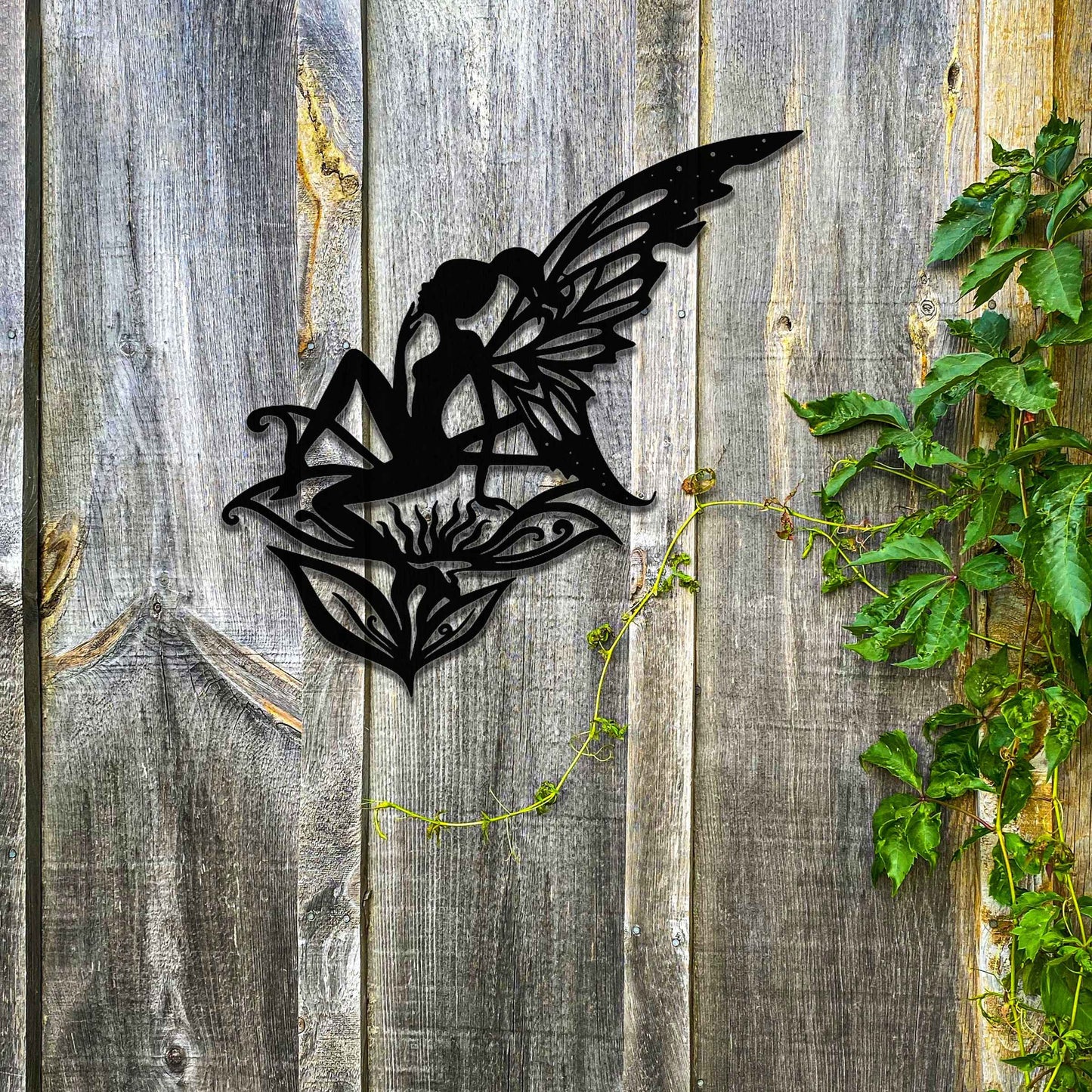 This design features a fairy perched gracefully on a stylized flower, with delicate wings outstretched. The intricate patterns on the wings and the fluid lines of the fairy's pose create a sense of ethereal beauty and enchantment.