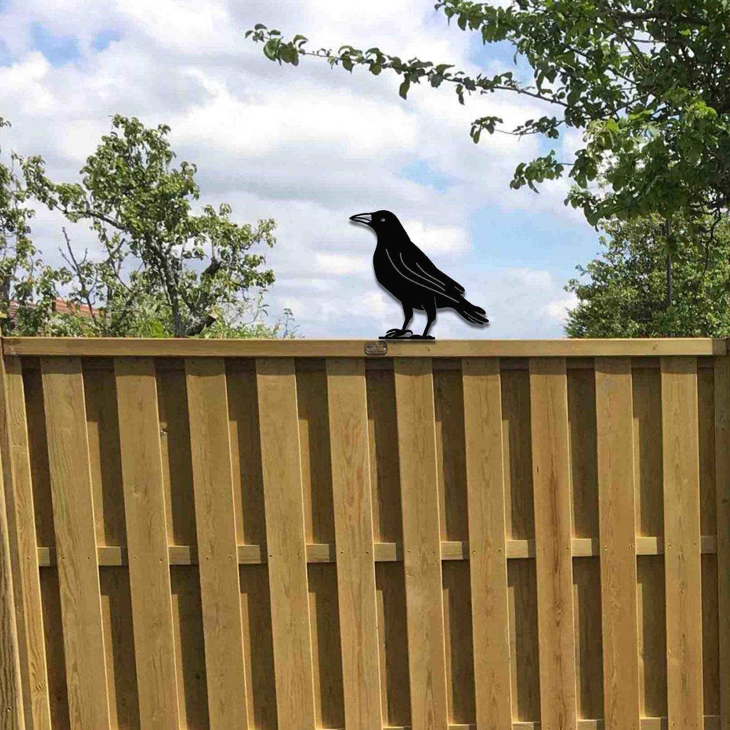 Metal garden decoration featuring a crow silhouette with a rustic finish, designed to sit atop fences or garden posts, adding a bold and distinctive touch to outdoor spaces.