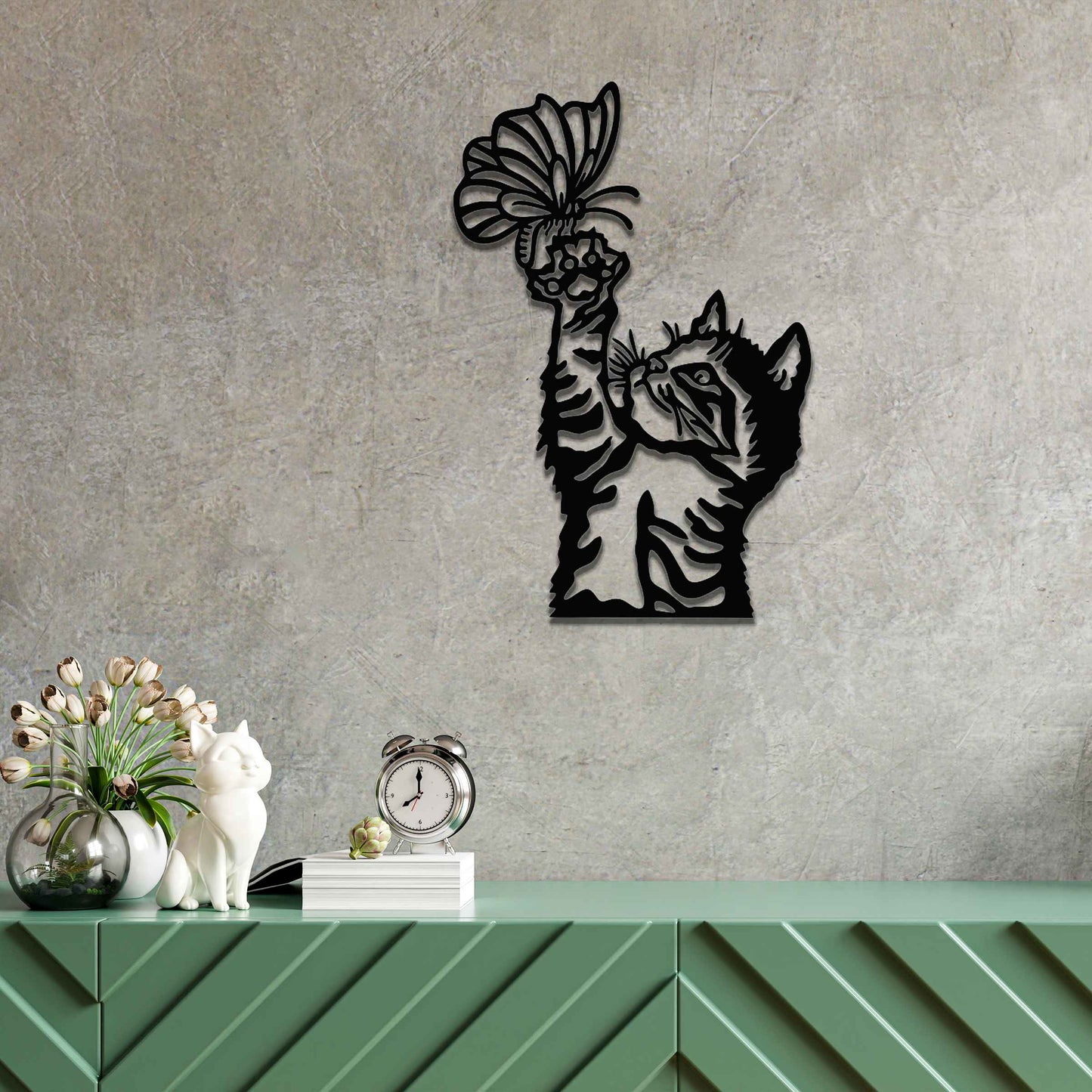 Metal wall art featuring a curious kitten playfully reaching for a butterfly, adding a delightful touch of charm and whimsy to modern indoor or outdoor decor, displayed on a neutral wall.