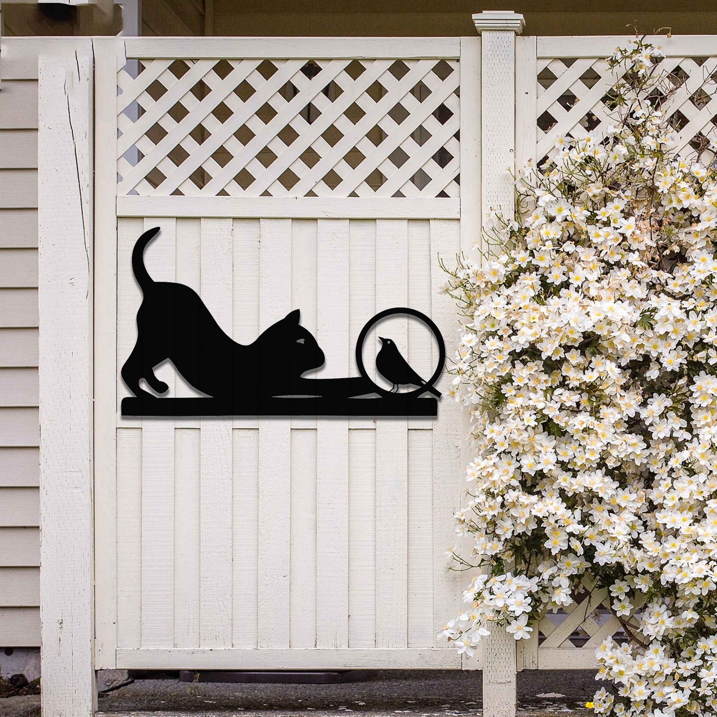 Metal wall art featuring a playful cat crouching in curiosity with a bird perched nearby, perfect for adding a touch of whimsy and nature-inspired charm to your garden, fence, or outdoor decor.