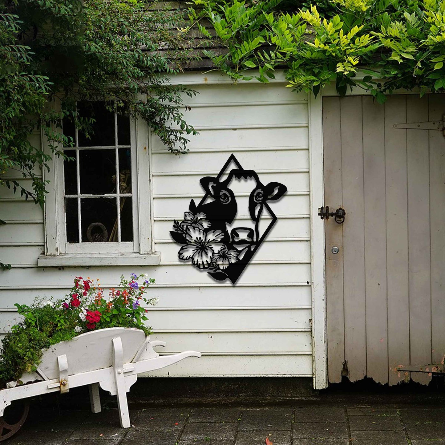 The design features a cow's face framed by a geometric shape, with flowers on its side, combining natural and abstract elements in a modern, stylized way.