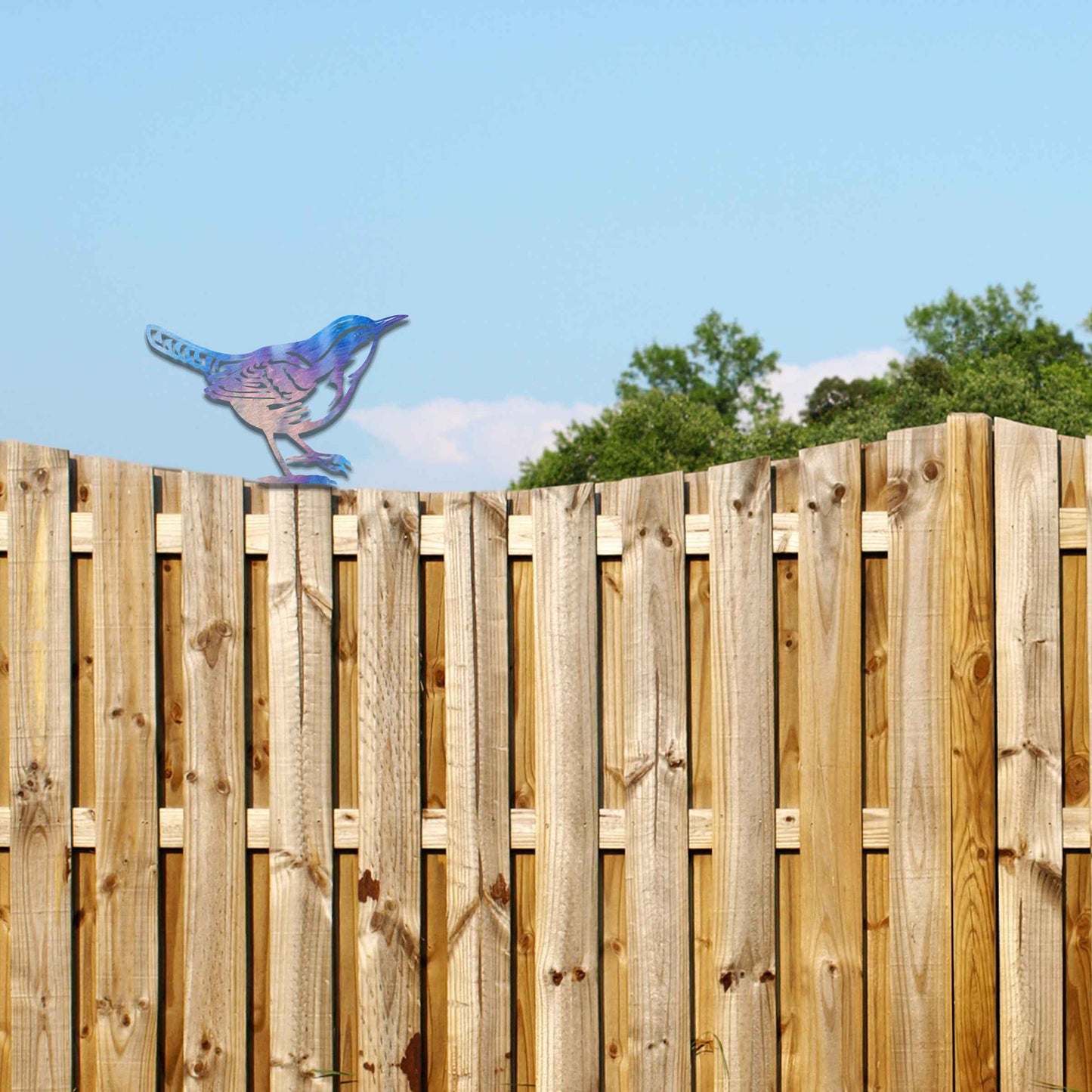 Metal garden decoration featuring a wren silhouette with intricate cutout details and a rustic finish, designed to sit atop fences or posts, adding a delicate and natural charm to outdoor spaces.