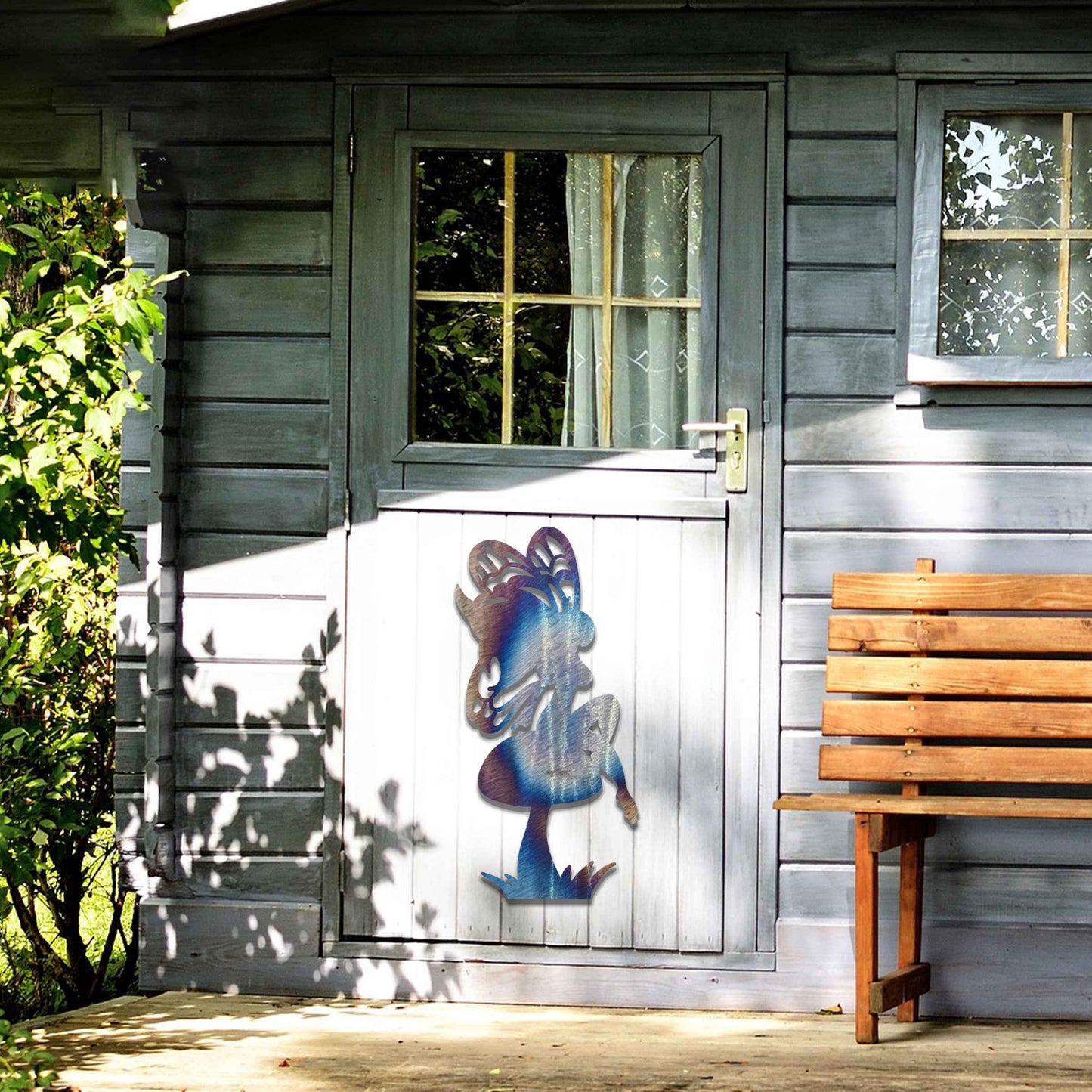 This image features a fairy perched on a mushroom, its silhouette highlighted by intricate wings. The whimsical design is enhanced by the playful stance of the fairy, adding a touch of enchantment to any garden or outdoor space.