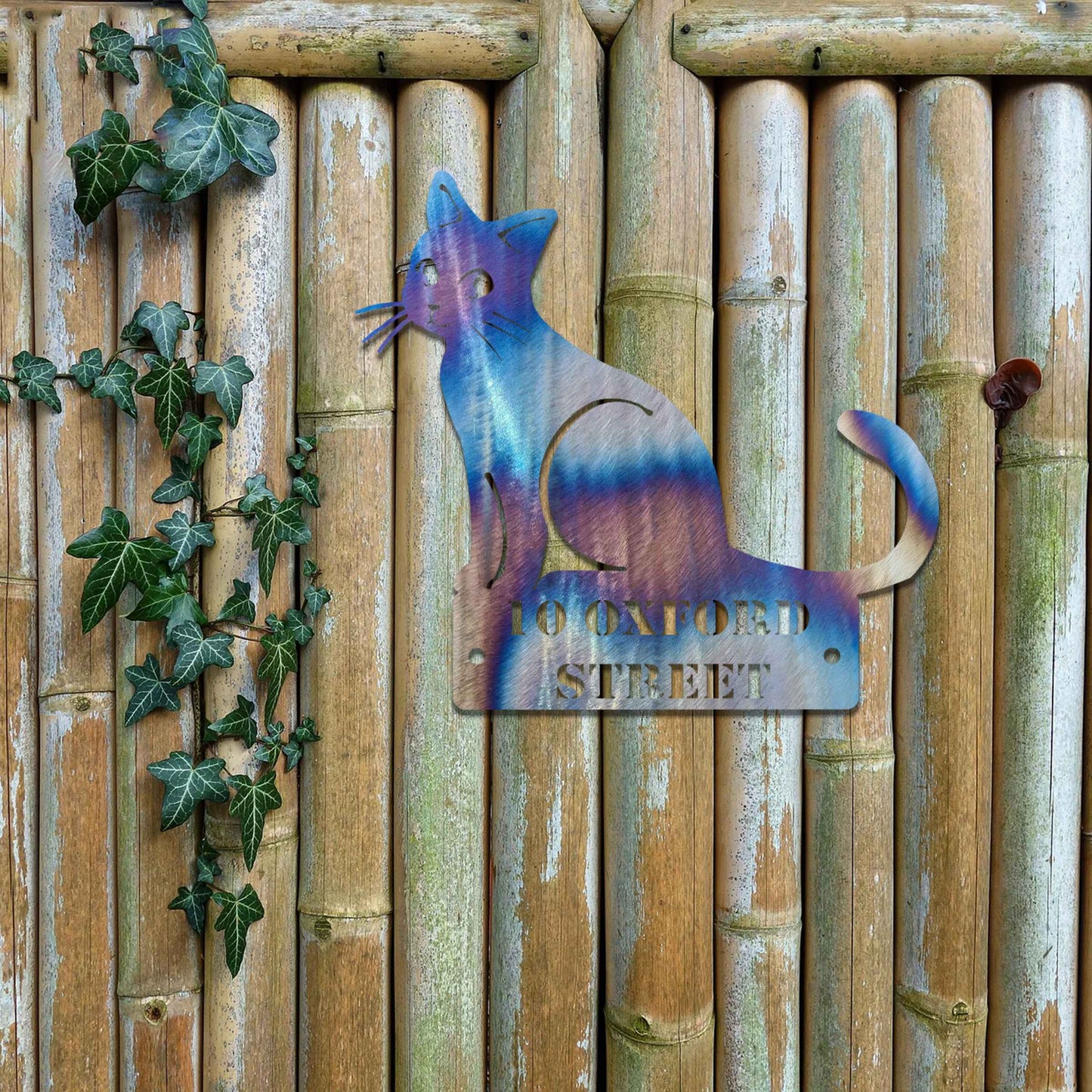 Metal garden decoration featuring a sleek sitting cat silhouette with a personalised address plaque, combining practicality with artistic charm for outdoor walls, fences, or gates.