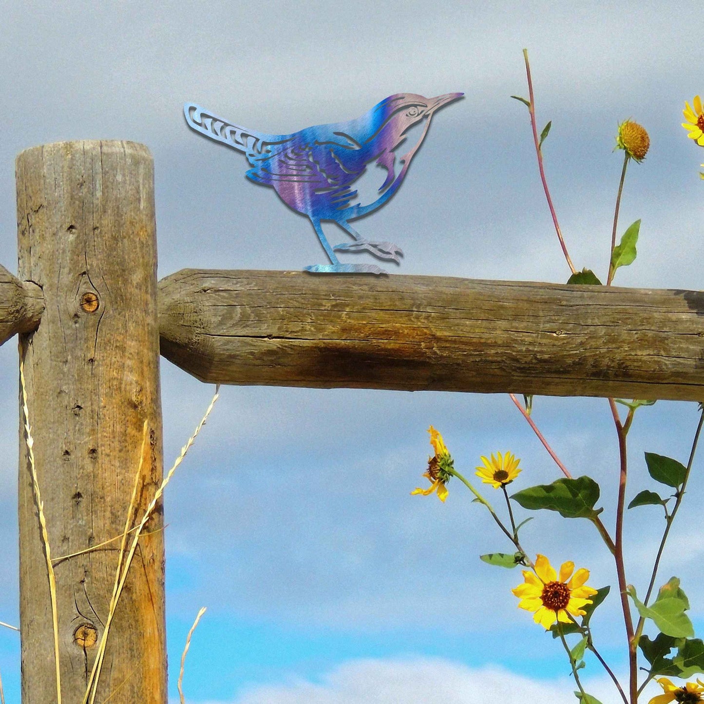 Metal garden decoration featuring a wren silhouette with intricate cutout details and a rustic finish, designed to sit atop fences or posts, adding a delicate and natural charm to outdoor spaces.