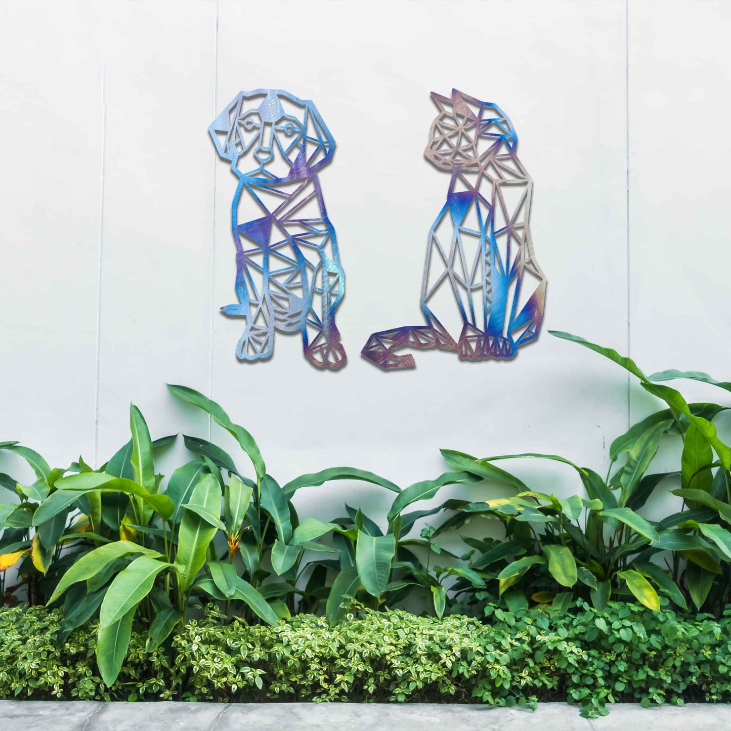 This image displays geometric-style black metal art featuring a dog and a cat, placed side by side. The angular, modern design of the animals contrasts beautifully with the natural greenery around, offering a stylish touch to the surrounding space.