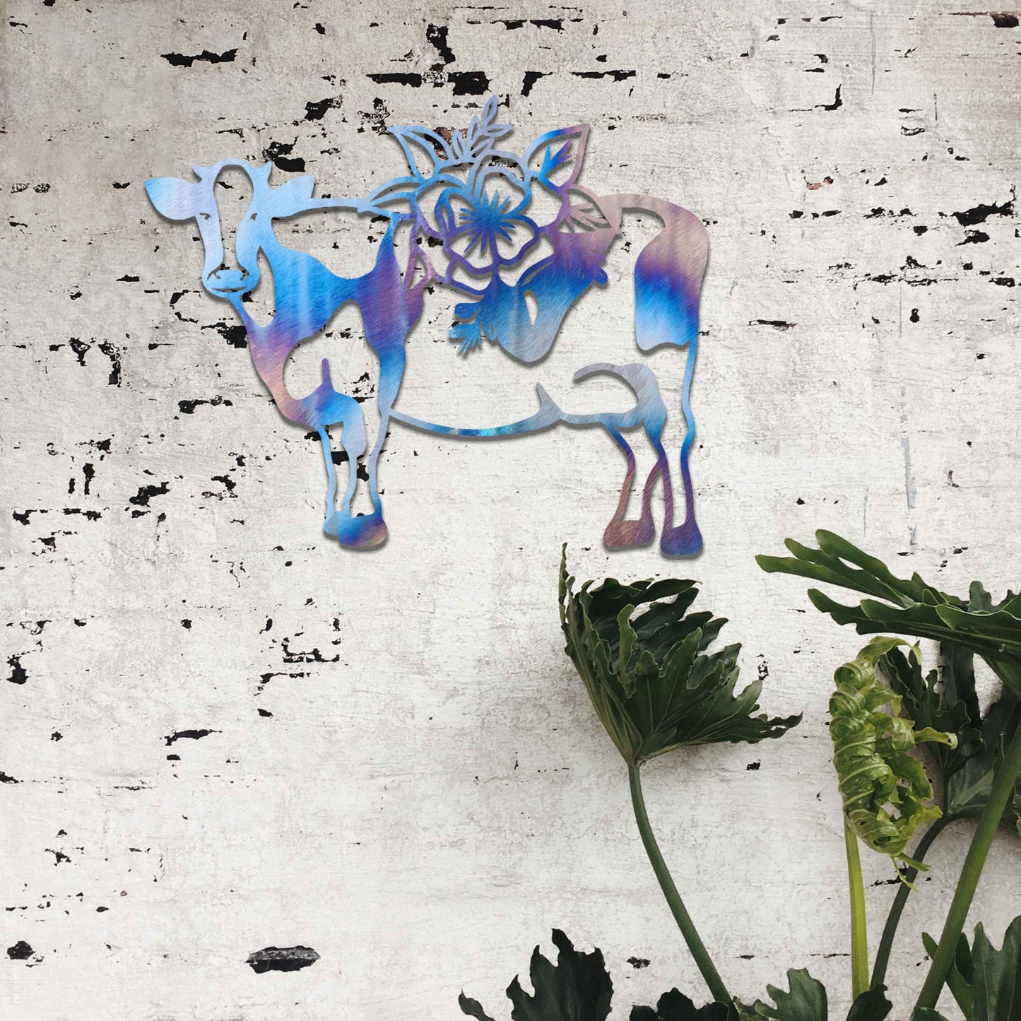 The artwork showcases a cow adorned with a detailed floral design on its back. The cow's form is outlined in a minimalist style, with the intricate flowers contrasting against its simple body, adding a decorative and natural element to the piece.